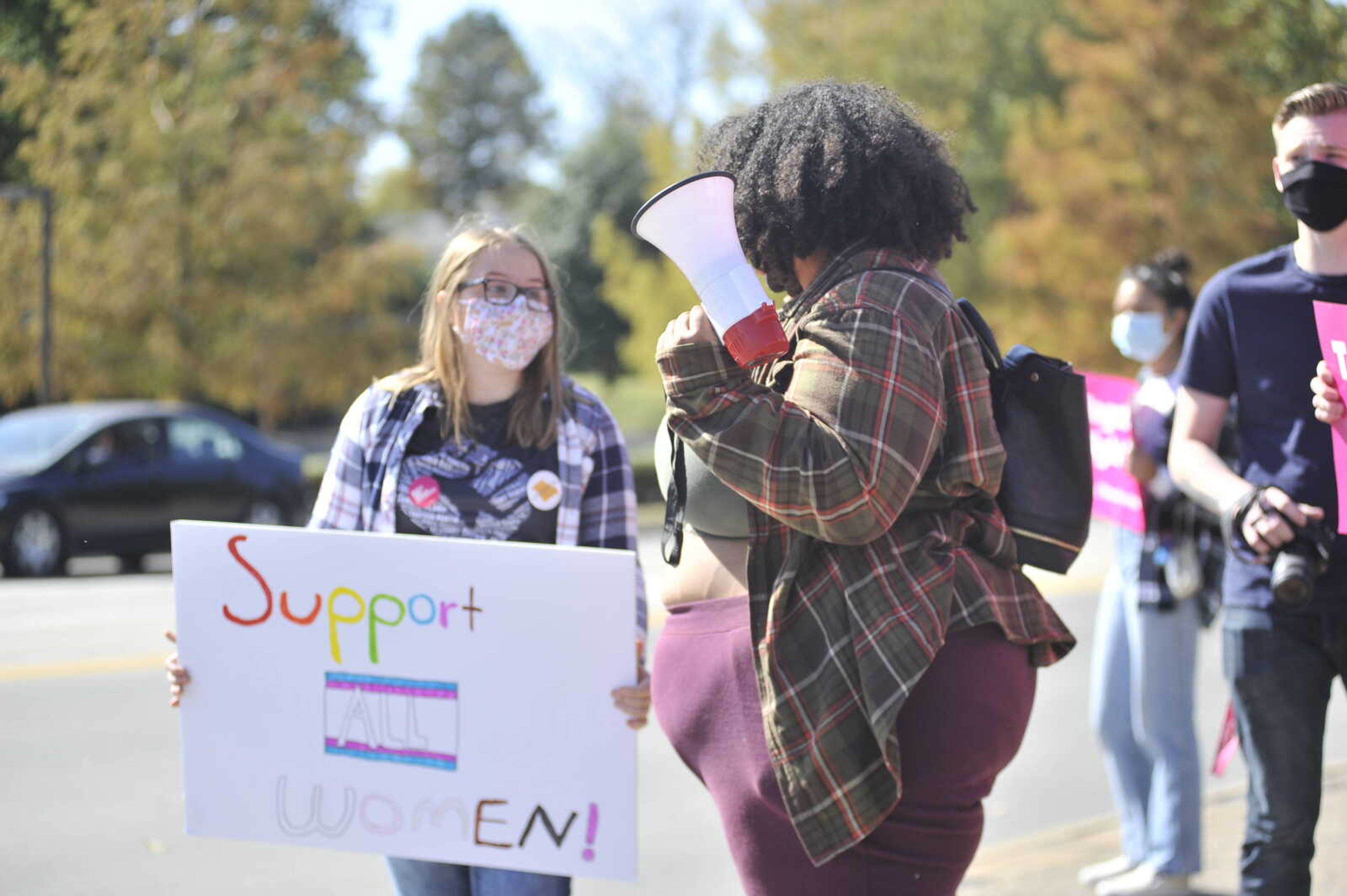 Emily Peters (left) holds a handwritten sign and chants in protest alongside McKenzie Eston at the SEMO Women's March on Saturday, Oct. 17, 2020, at Freedom Corner in Cape Girardeau.&nbsp;