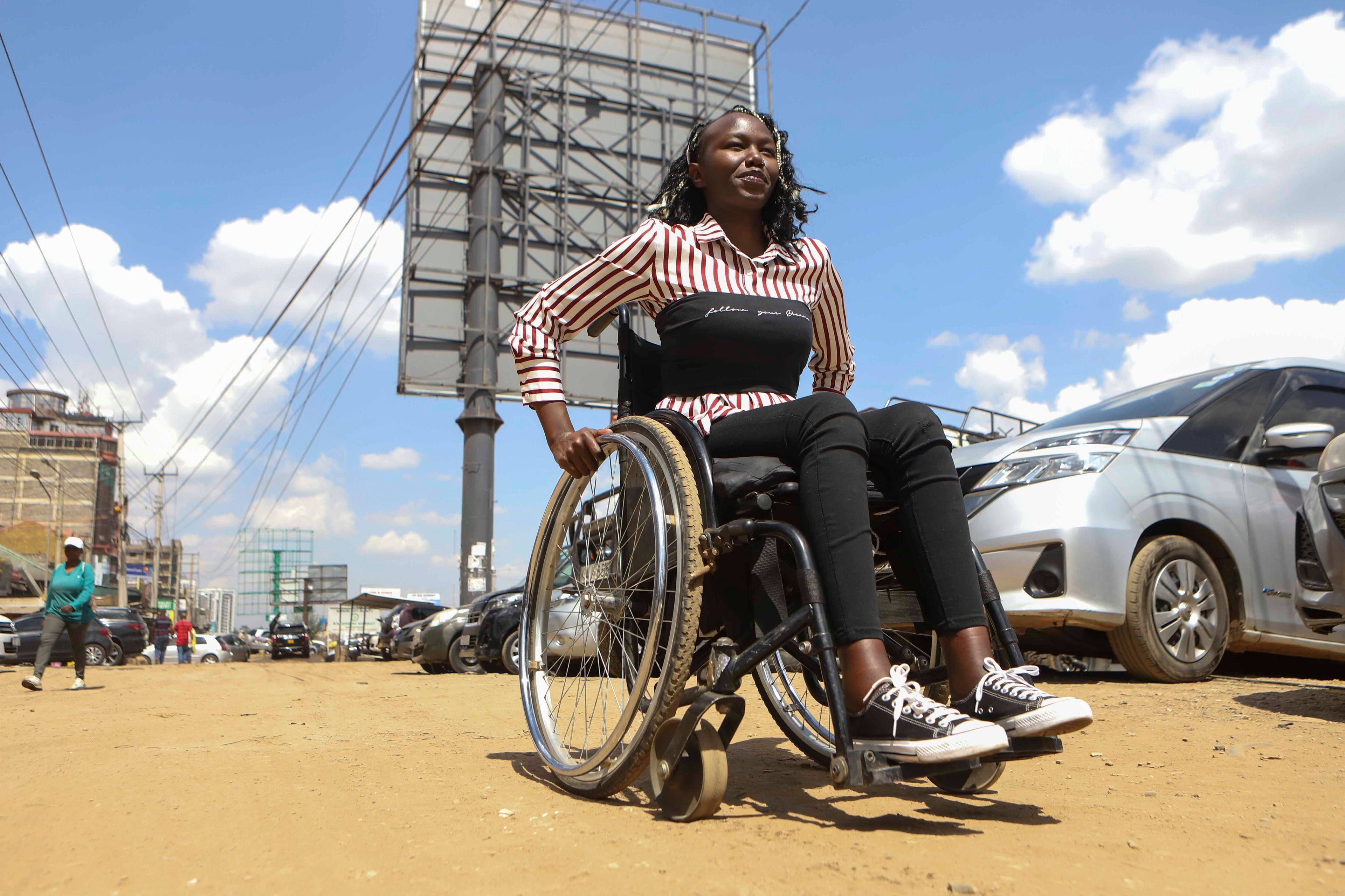 Carol Mwikali rides around on a wheelchair in Nairobi, Kenya, Wednesday, Oct. 9, 2024. (AP Photo/Andrew Kasuku)