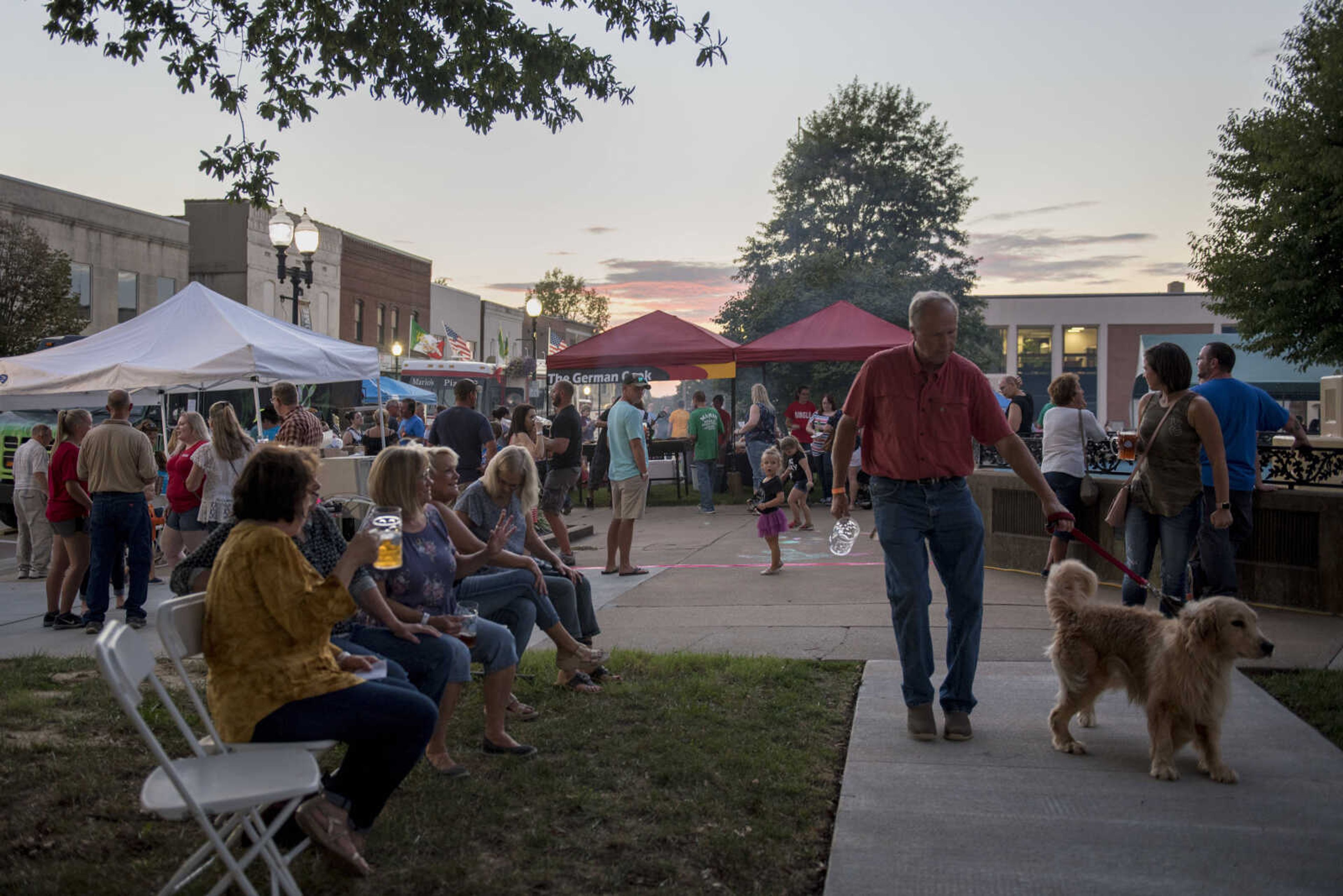 Patrons are seen during Uptown Jackson Oktoberfest's opening night Friday, Oct. 5, 2018.