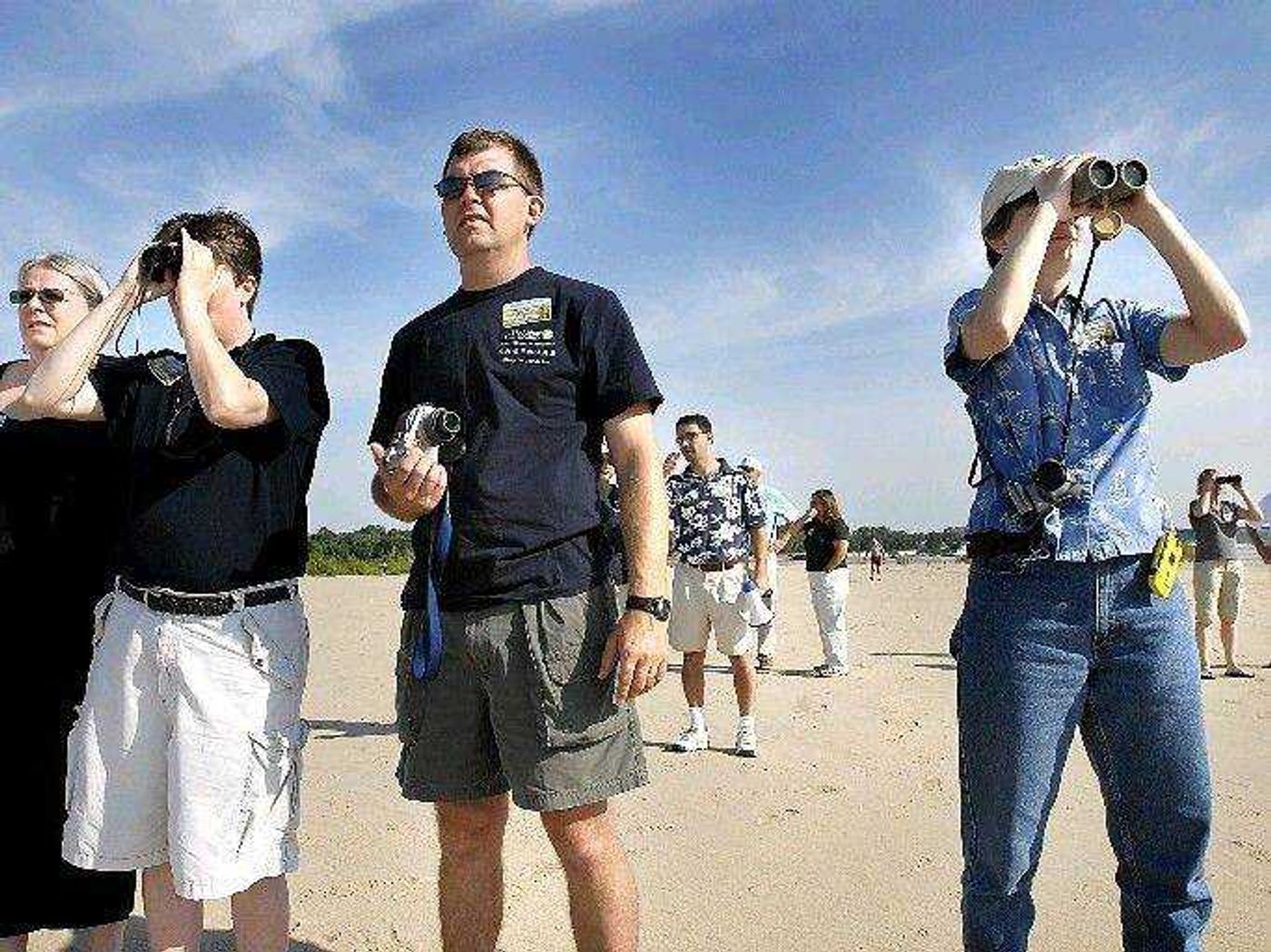 Joyce Collins, left, Todd Strole and June Jeffries watch least tern birds on Marquette Island on the Mississippi River south of Cape Girardeau on June 20, 2007, during the River Resources Action Team Environmental Coordination Trip hosted by the U.S. Army Corps of Engineers. The three represent U.S. Fish and Wildlife Services, The Nature Conservancy and the Corps of Engineers, respectively, several of the governmental and nongovernmental entities trying to coordinate efforts on the river. (Kit Doyle)