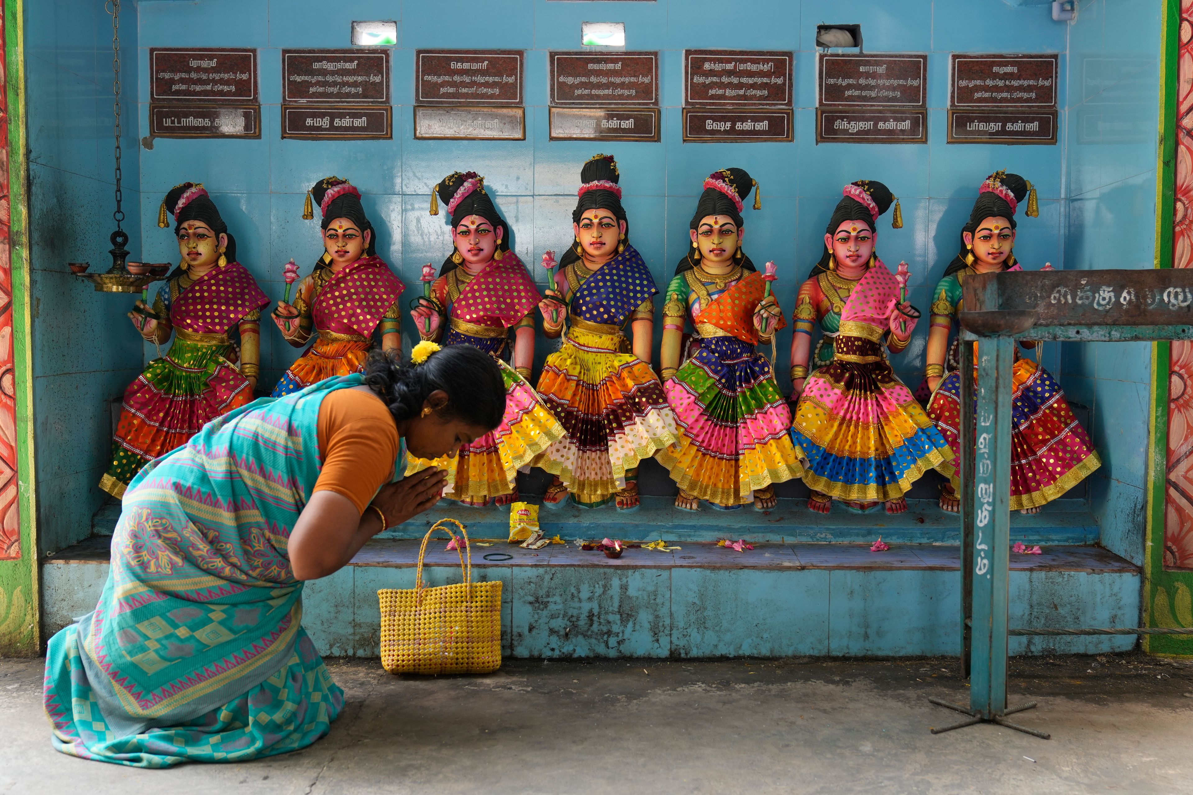 A villager prays in front of the idols of Hindu goddesses after special prayers for the victory of Democratic presidential nominee Vice President Kamala Harris, at Sri Dharmasastha temple in Thulasendrapuram, the ancestral village of Harris, in Tamil Nadu state, India, Tuesday, Nov. 5, 2024. (AP Photo/Aijaz Rahi)