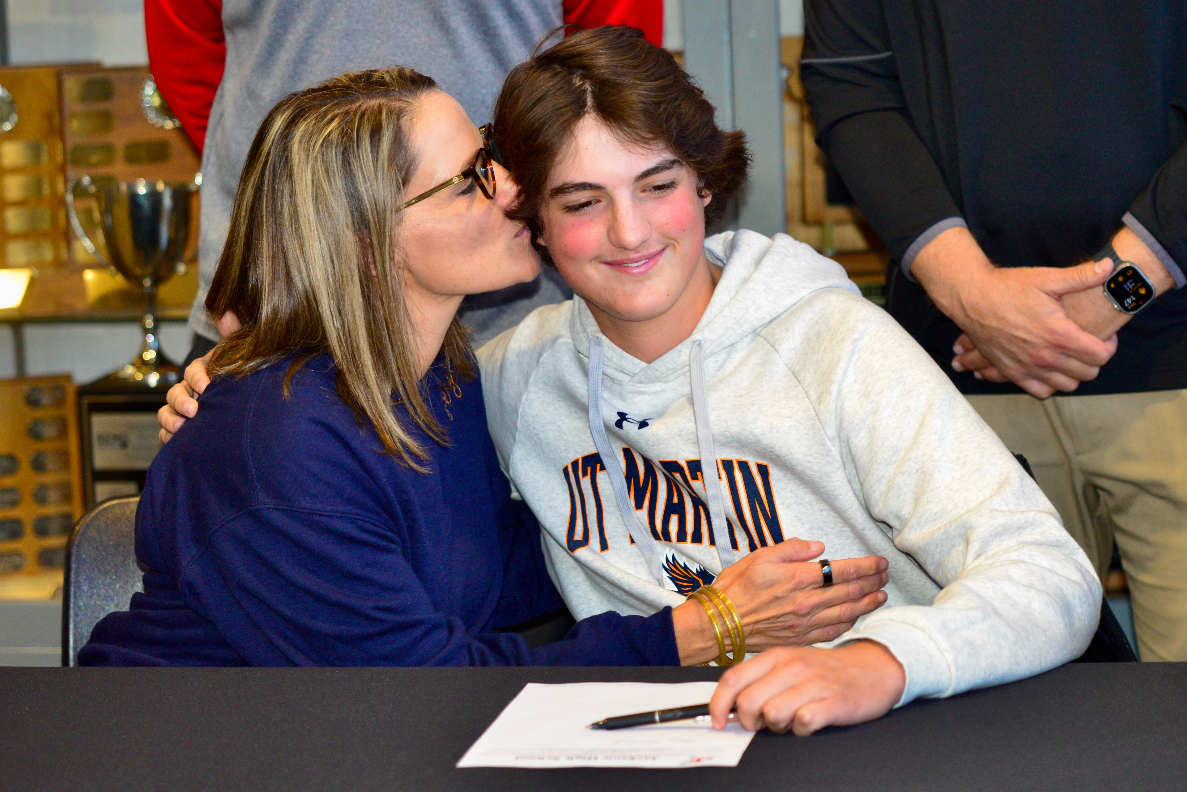 Jackson golfer Ian Lambert is embraced by his mother after signing his national letter of intent to play golf collegiately for UT Martin on Thursday, Nov. 21, at Jackson High School in Jackson.