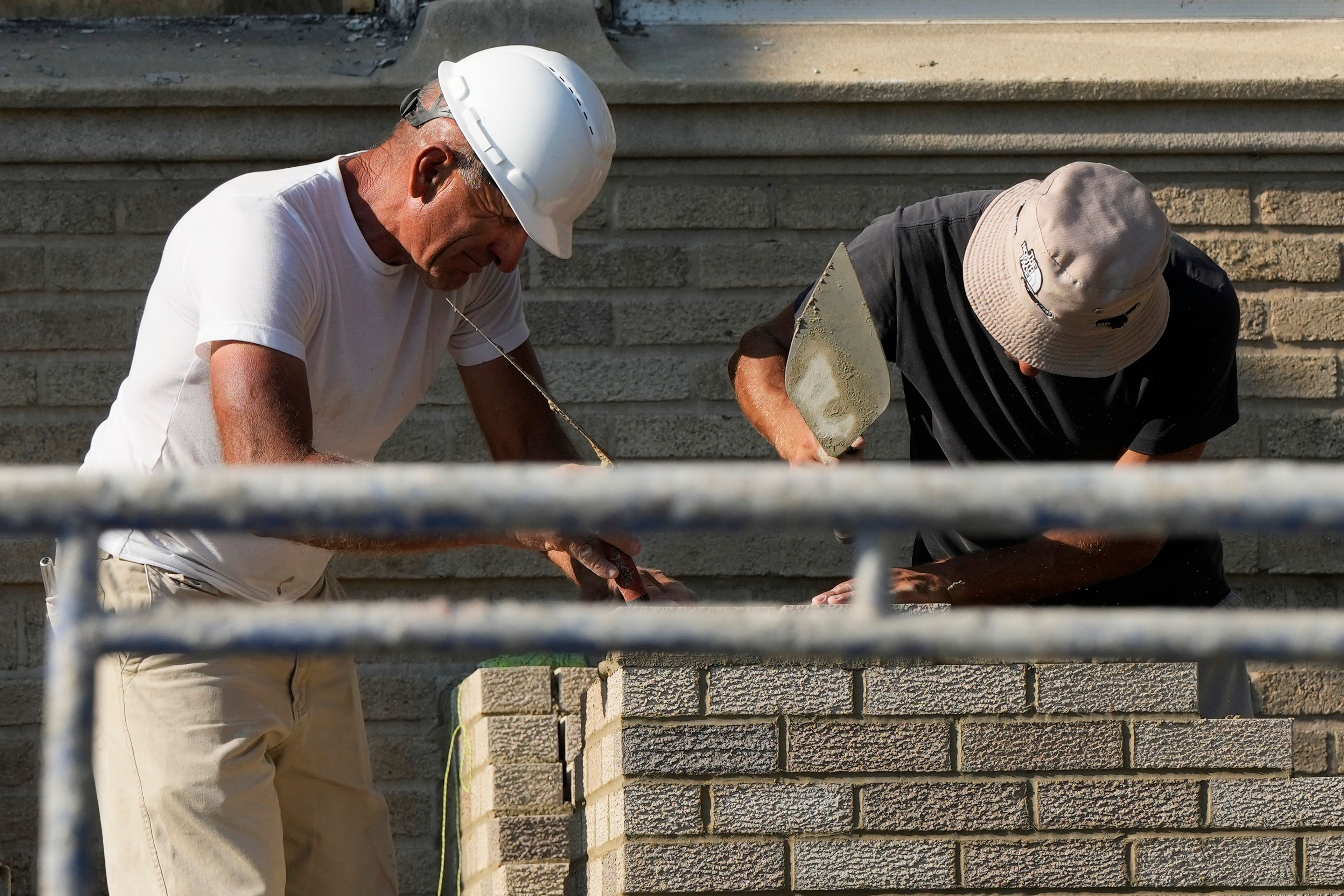 Construction workers work at a residential building site in Chicago, Thursday, Aug. 29, 2024. (AP Photo/Nam Y. Huh)