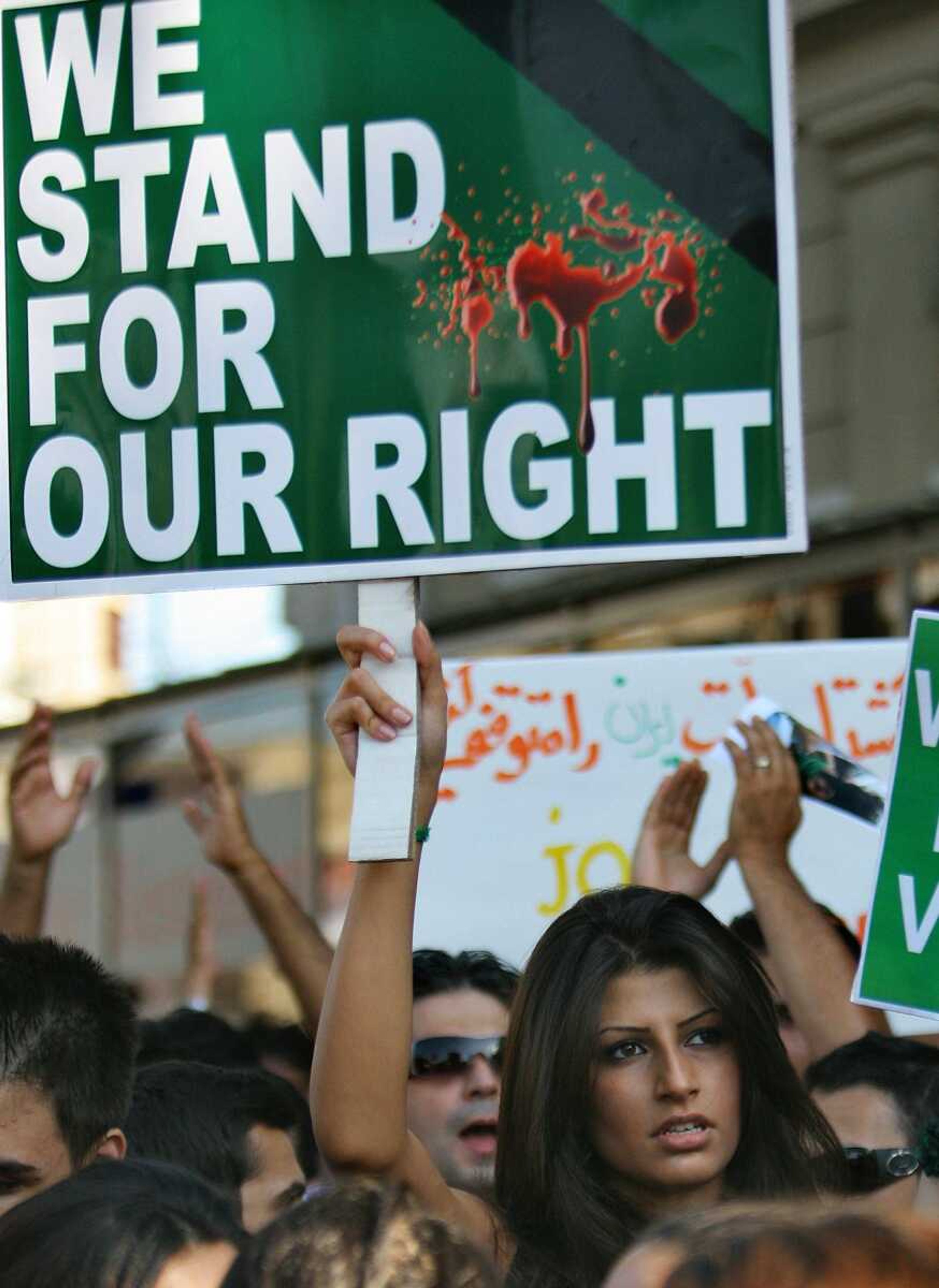 A demonstrator holds a banner during a rally Friday to protest the outcome of the Iranian election outside the Iranian Embassy in Bucharest, Romania. (Associated Press)