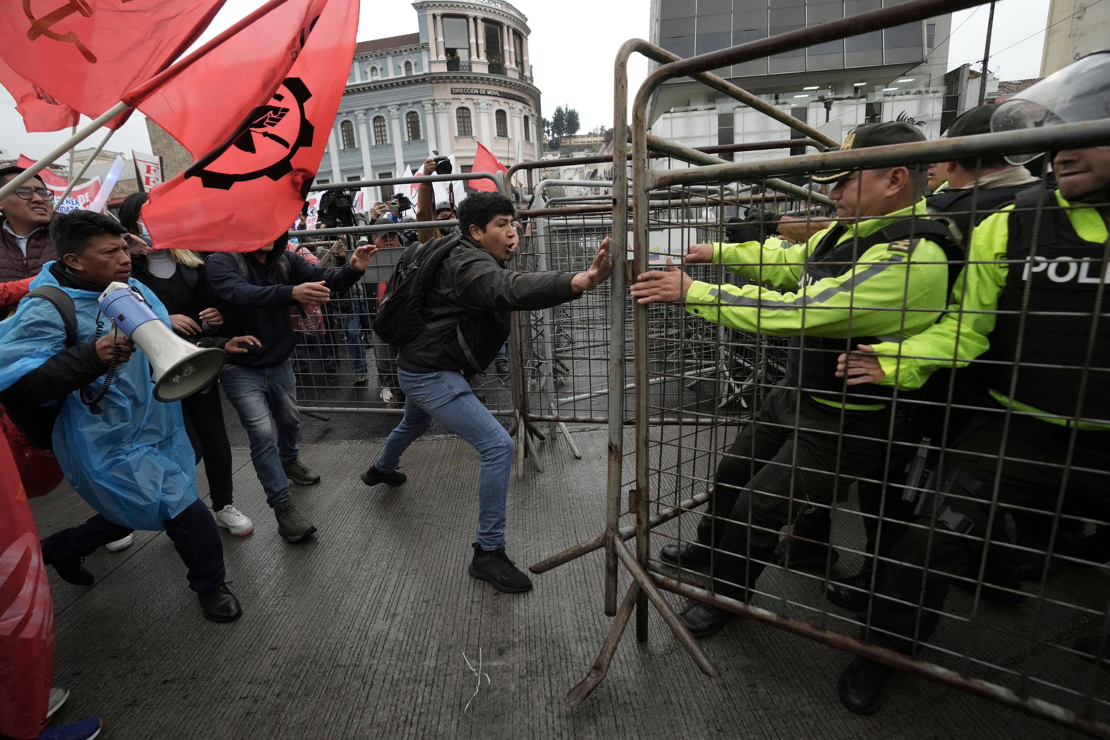 Anti-government protesters challenge police during a demonstration against electricity rationing in Quito, Ecuador, Thursday, Nov. 21, 2024. (AP Photo/Dolores Ochoa)