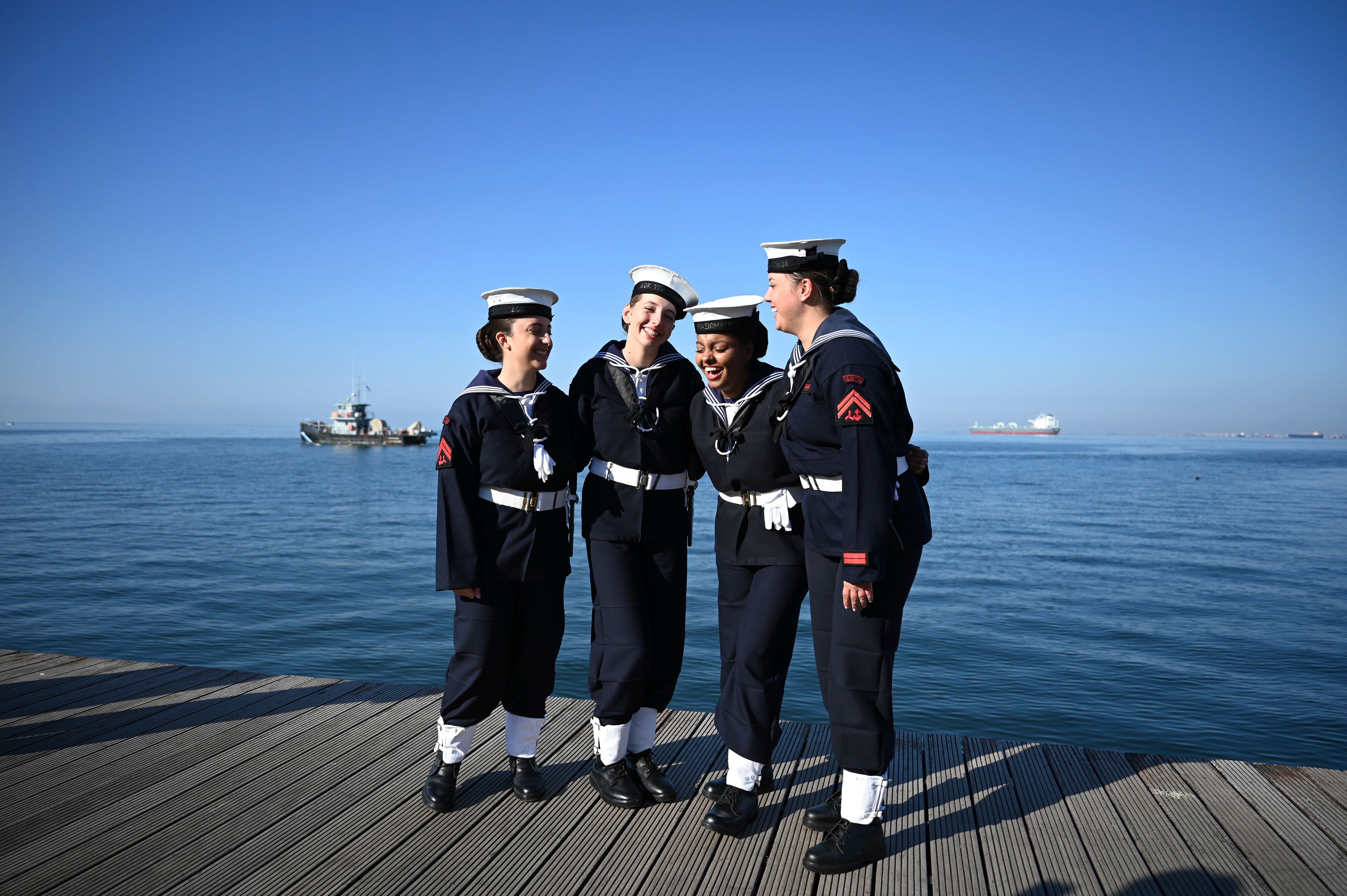 Students of the Hellenic Naval Academy pose for a photograph before the military parade to celebrate the country's entry into World War II after it refused to align itself with a belligerent fascist Italy in 1940, in Thessaloniki, northern Greece, Monday, Oct. 28, 2024. (AP Photo/Giannis Papanikos)