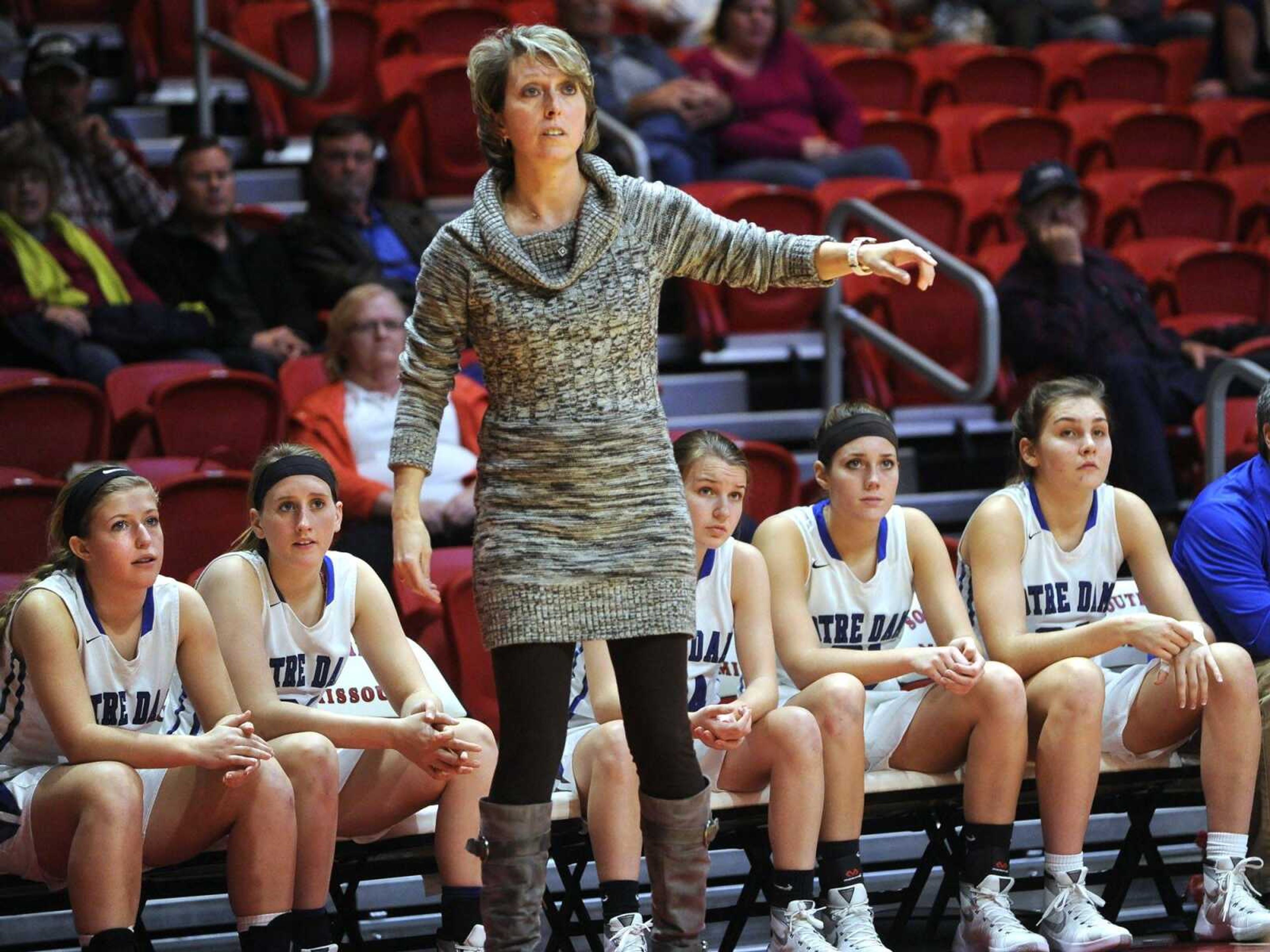 Notre Dame coach Renee Peters and her players on the bench watch action against Cape Central during the fourth quarter in a first-round game of the Kelso Supply Holiday Classic Sunday, Dec. 20, 2015 at the Show Me Center. (Fred Lynch)