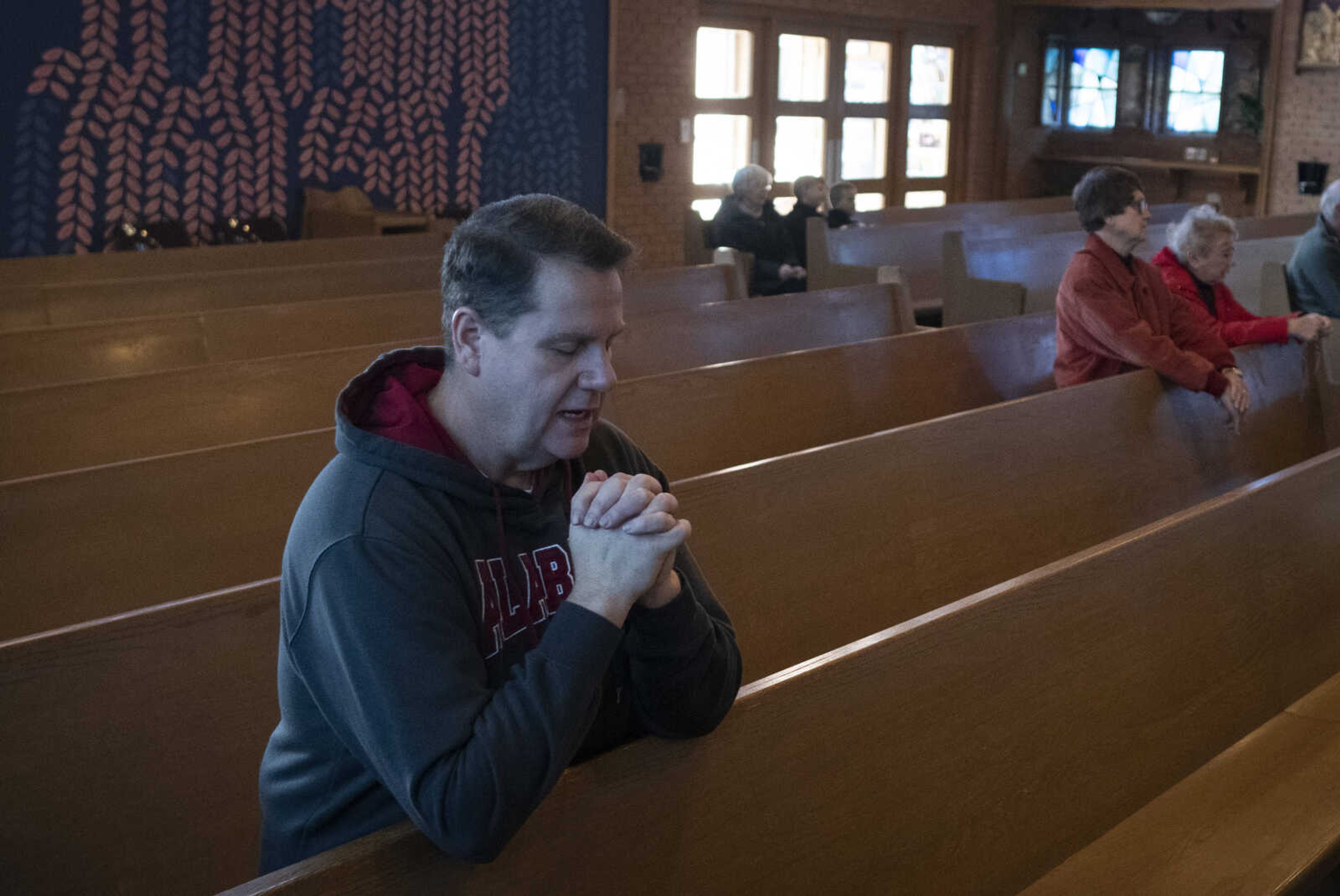 PJ Bess of Pocahontas, Missouri, takes part in a group Rosary prayer before the march portion of a March for Life on Saturday, Jan. 18, 2020, at Immaculate Conception Catholic Church in Jackson.