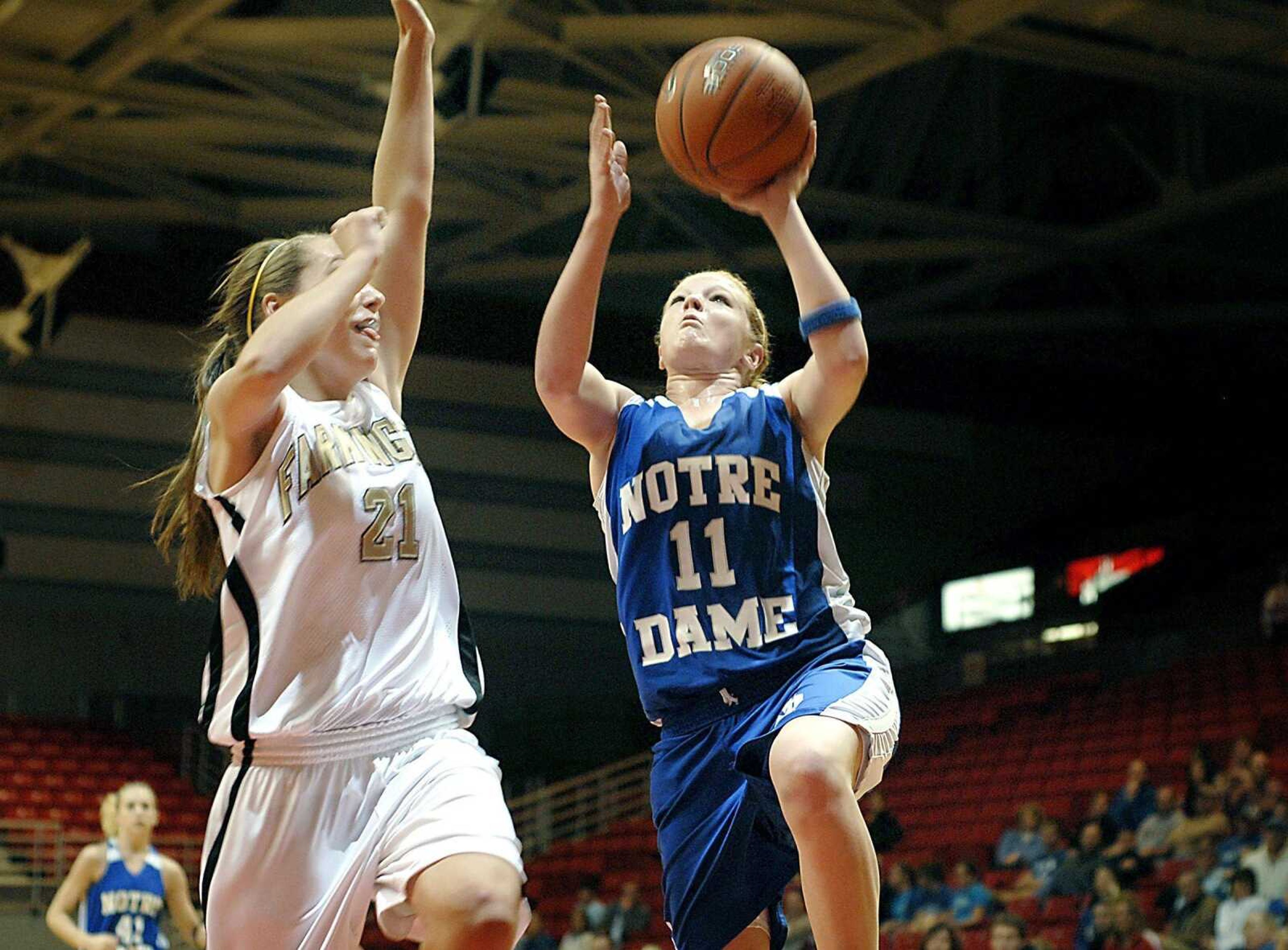 Notre Dame's Alex Fowler went for a layup against Farmington defender Ashley Jenson in the St. Francis Medical Center Holiday Classic championship game Friday night, December 21, 2007, at the Show Me Center. (Kit Doyle)