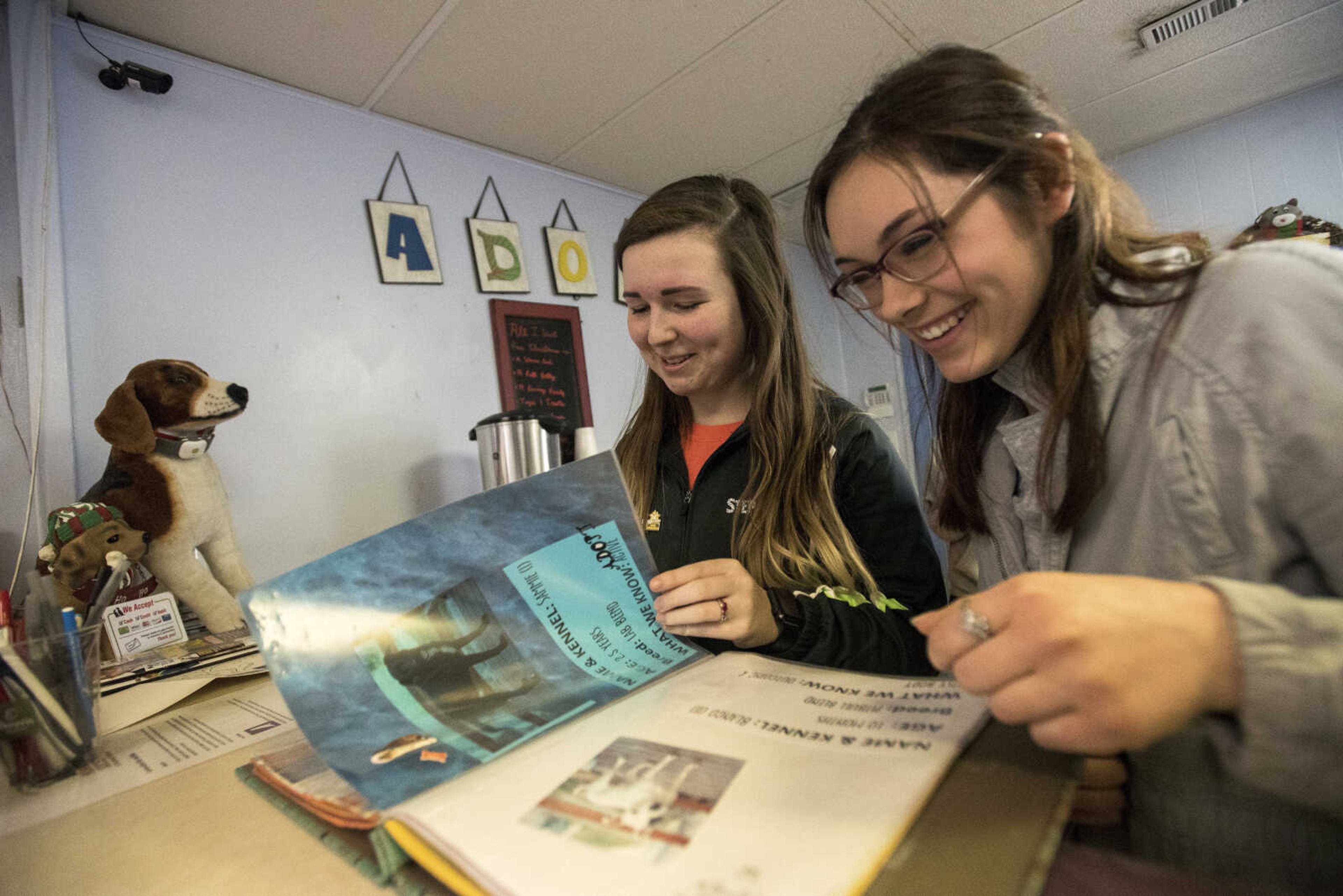 Stephanie Elefson, left, and Ariel Gralewski look at dogs for adoption at the 40th anniversary of the Humane Society of Southeast Missouri Saturday, Dec. 16 , 2017 in Cape Girardeau.