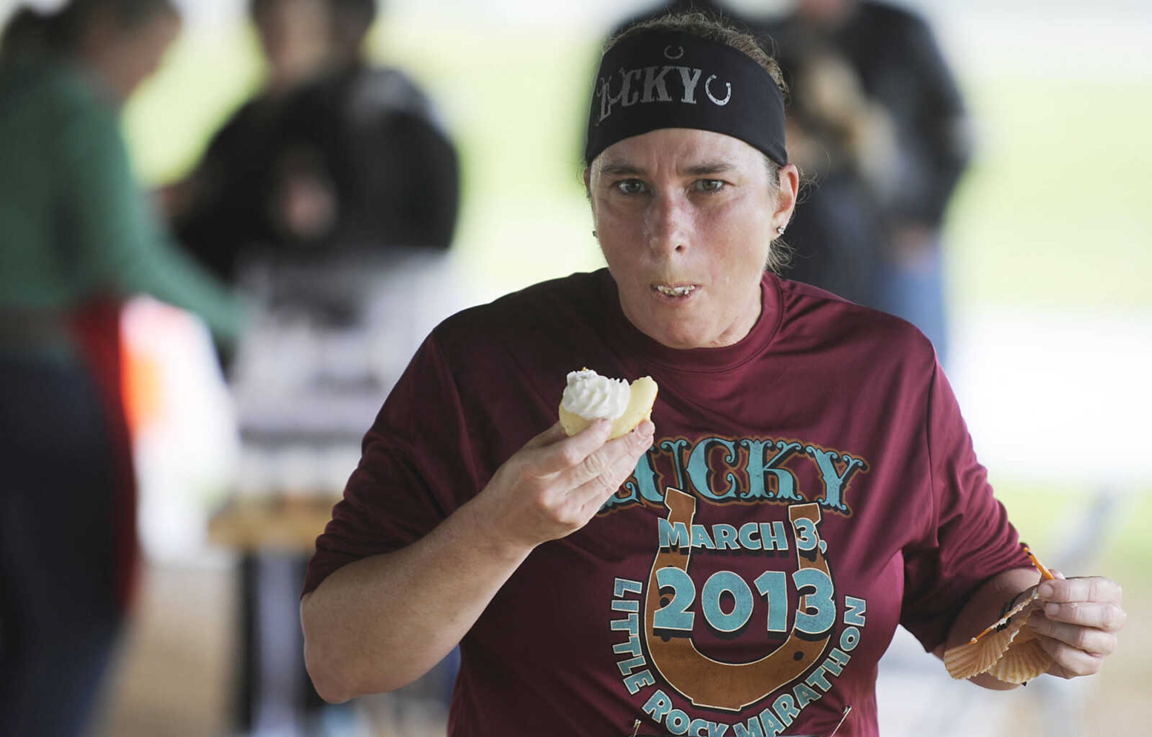 Competitors hurriedly eat a cupcakes during the 2013 Cupcake Challenge Sunday, May 5, at Arena Park in Cape Girardeau. Runners could have time deducted from their finish time for every cupcake they ate during the the 5k race, there was also a 1-mile kids race, which is a fundraiser for Hope Children's Home.