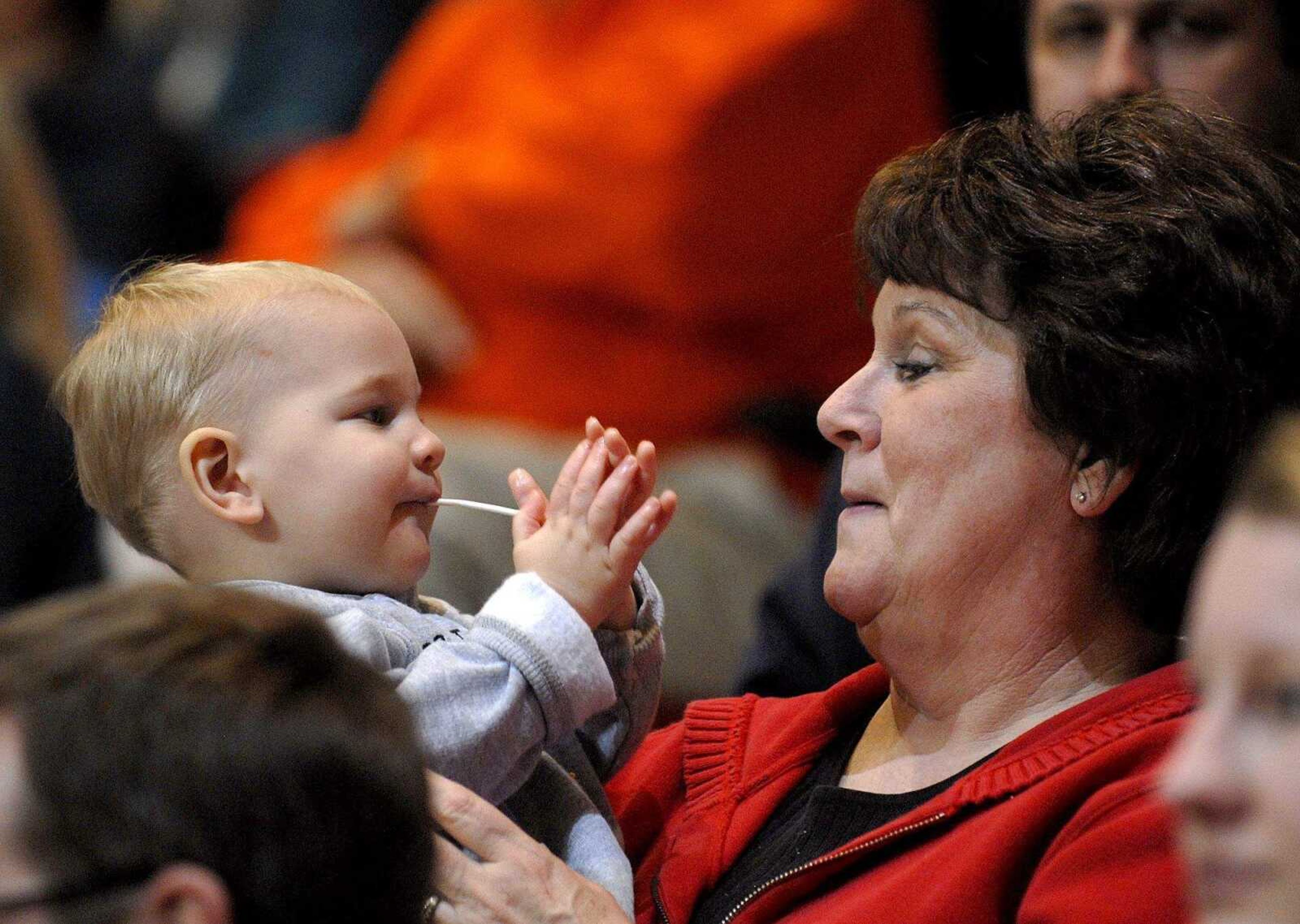 ELIZABETH DODD ~ edodd@semissourian.com
Brenda Bartels, of Jackson, right, teaches her grandson Nolan, 1, to clap for Jackson at the Christmas Tournament Tuesday at the Show Me Center.