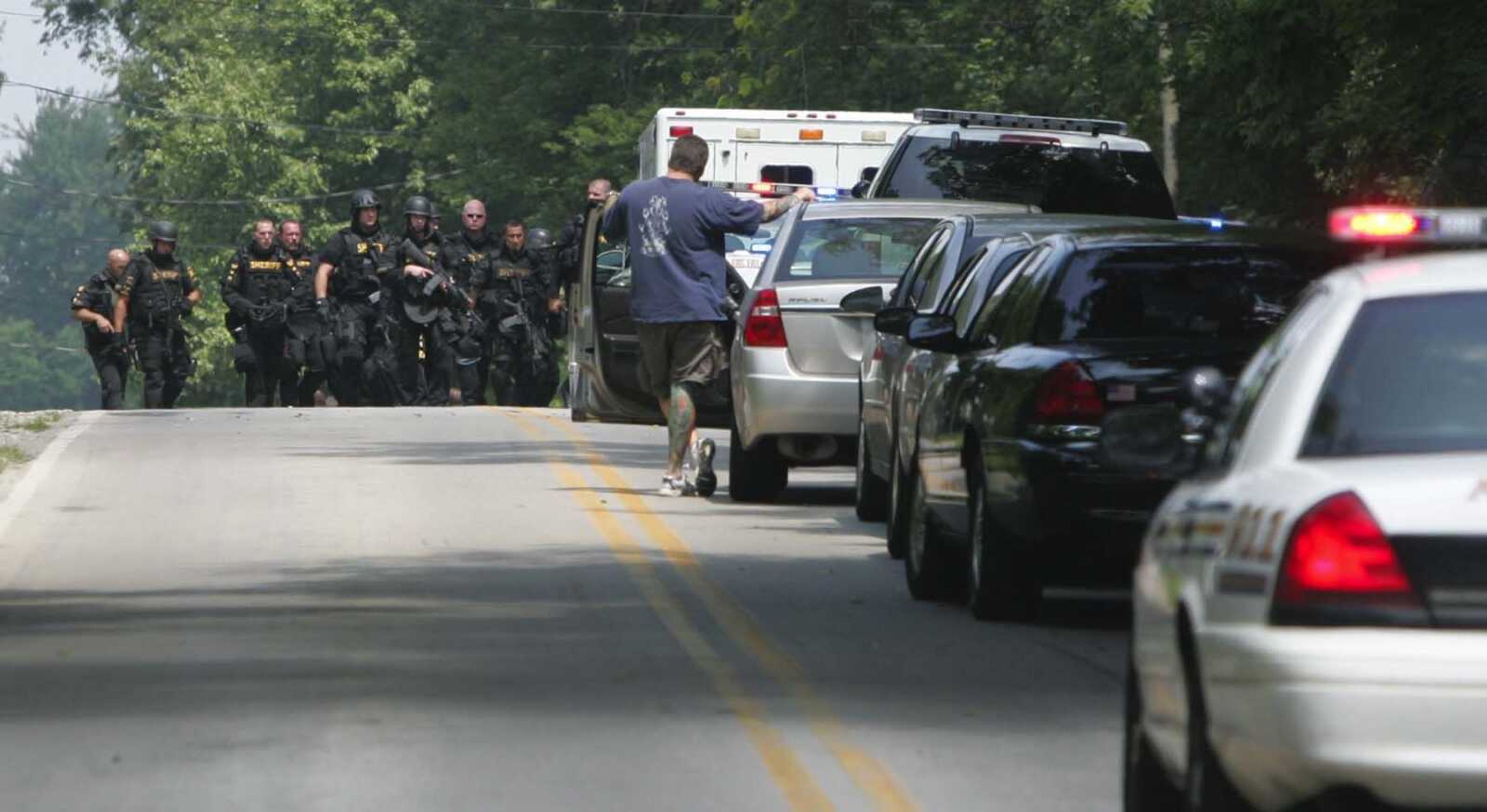 Members of the Summit County Sheriff Department leave the scene of a multiple fatal shooting Sunday, in Copley Township, Ohio. (Karen Schiely ~ Akron Beacon Journal)