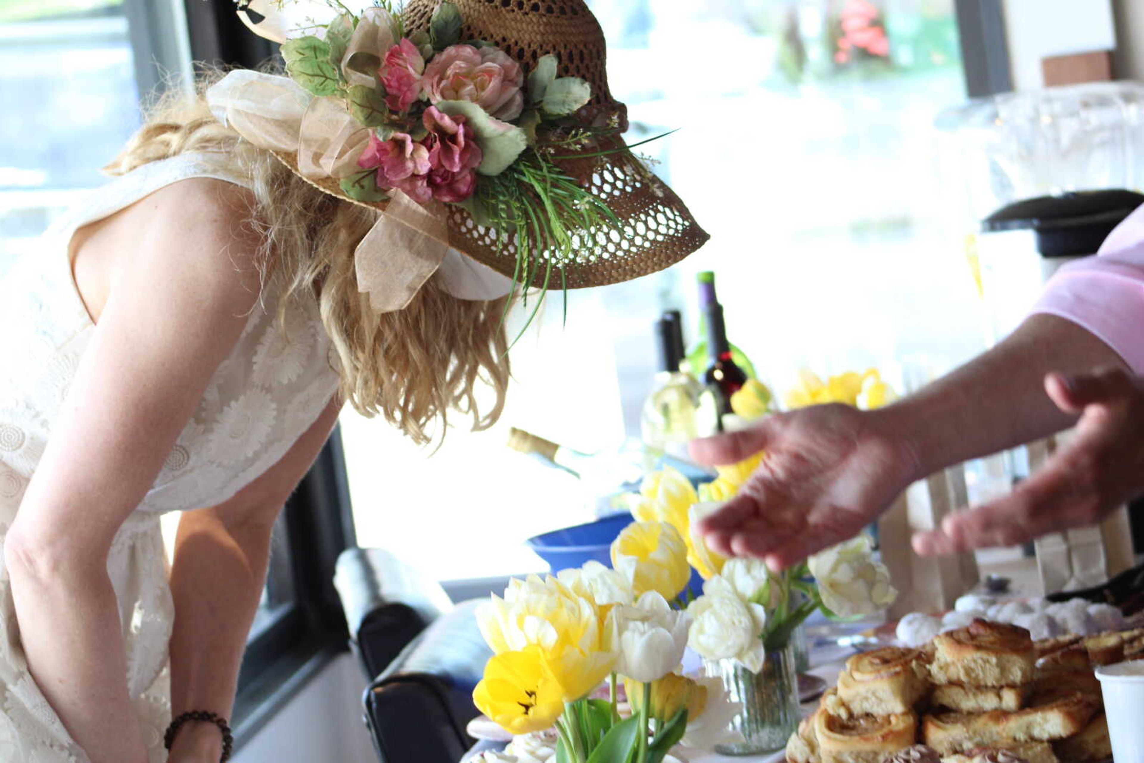 Kelly Downes, director at the Arts Council of Southeast Missouri, hands out a variety of treats to guests during Afternoon Tealight on Saturday, April 10, held at 16 N. Spanish St. in Cape Girardeau by the Arts Council of Southeast Missouri and 20 N. Pacific.&nbsp;