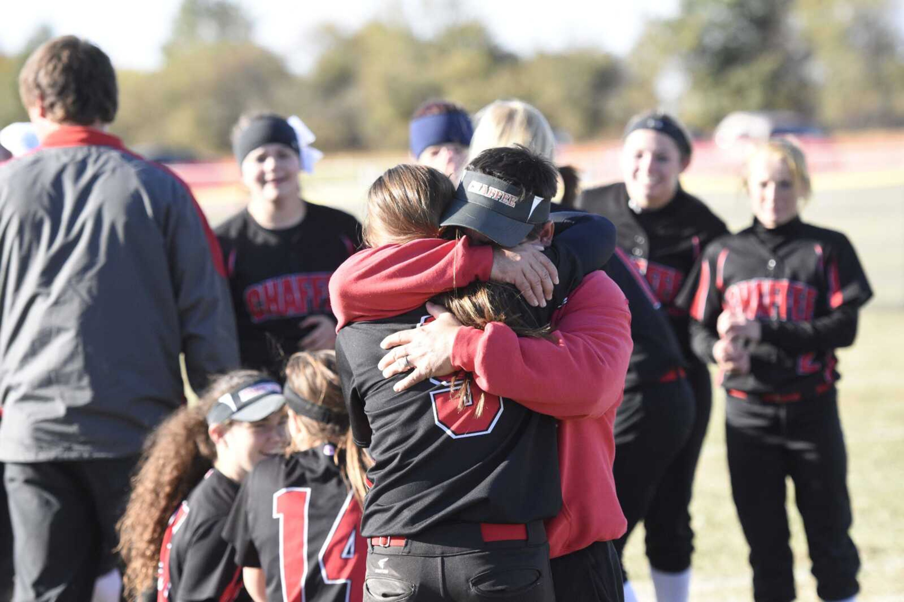 Chaffee assistant coach Joe Hendrix embraces his daughter, Madeline, after she hit a go-ahead two-run triple in the Red Devils 10-7 Class 1 quarterfinal victory Saturday in Vandalia, Missouri. (Ben Striker)