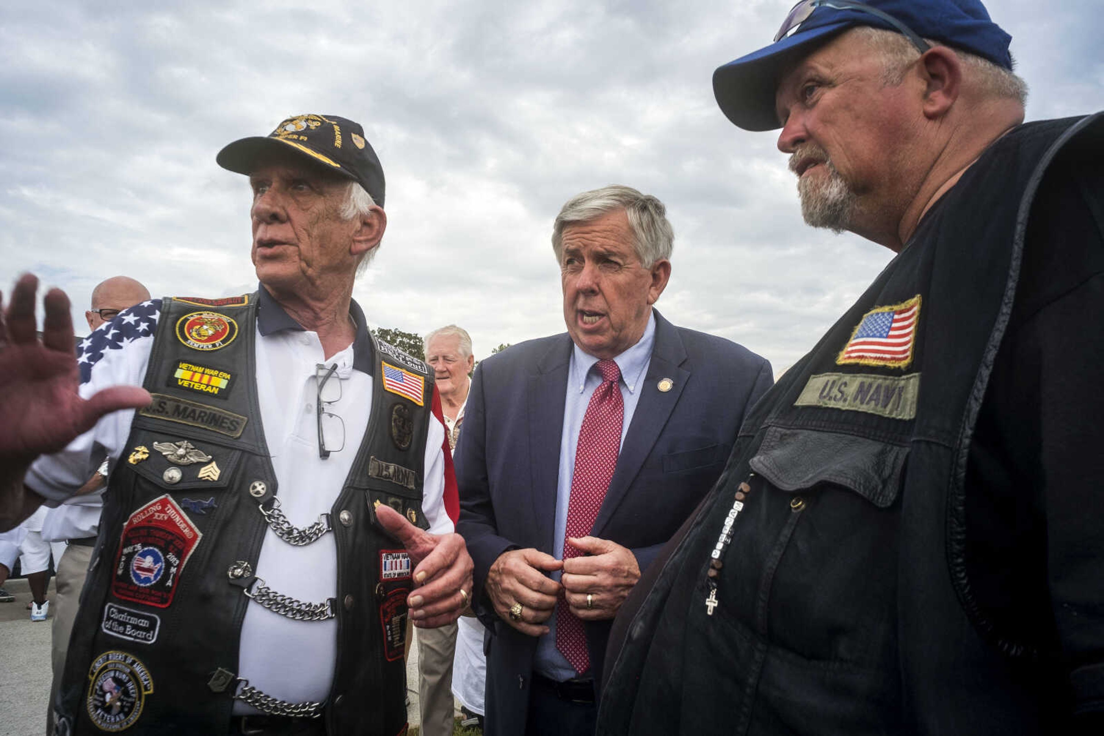 Missouri Governor Mike Parson, center, talks with organizers William Scott Magill, left, and Terry Willey, during the first-ever Missouri Vietnam Wall Run Saturday, Sept. 21, 2019, at the Missouri's National Veterans Memorial in Perryville.