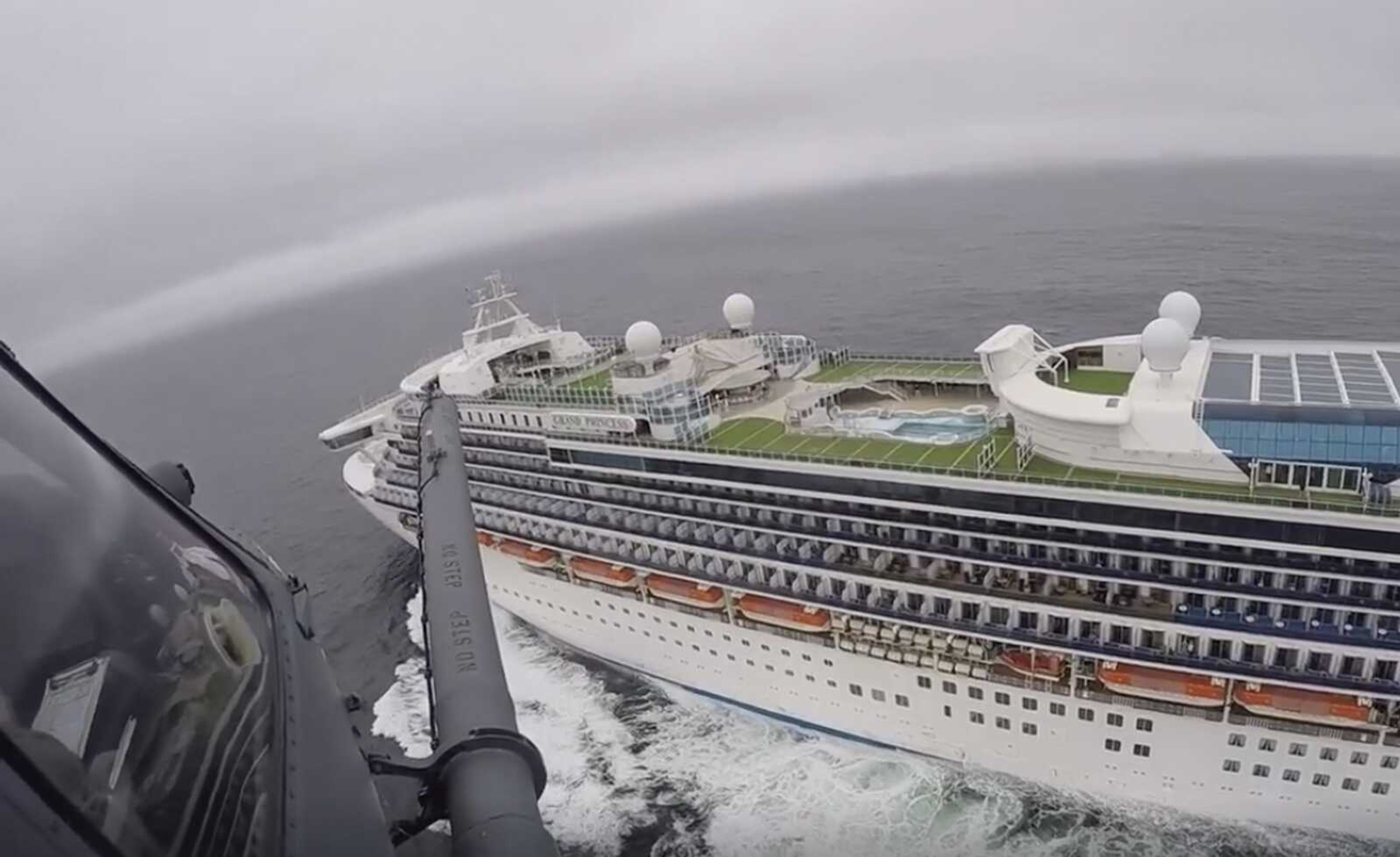 A helicopter carrying airmen with the 129th Rescue Wing flies over the Grand Princess cruise ship off the coast of California. Scrambling to keep the coronavirus at bay, officials ordered a cruise ship with 3,500 people aboard to stay back from the California coast Thursday until passengers and crew can be tested, after a traveler from its previous voyage died of the disease and others became infected.