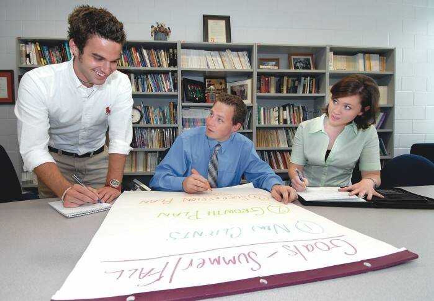 Dan Presson, left, Shad Burner and Emily Sikes worked on the Southeast Creative Communications' goals for the summer and fall during a meeting at Southeast Missouri State University on Wednesday.