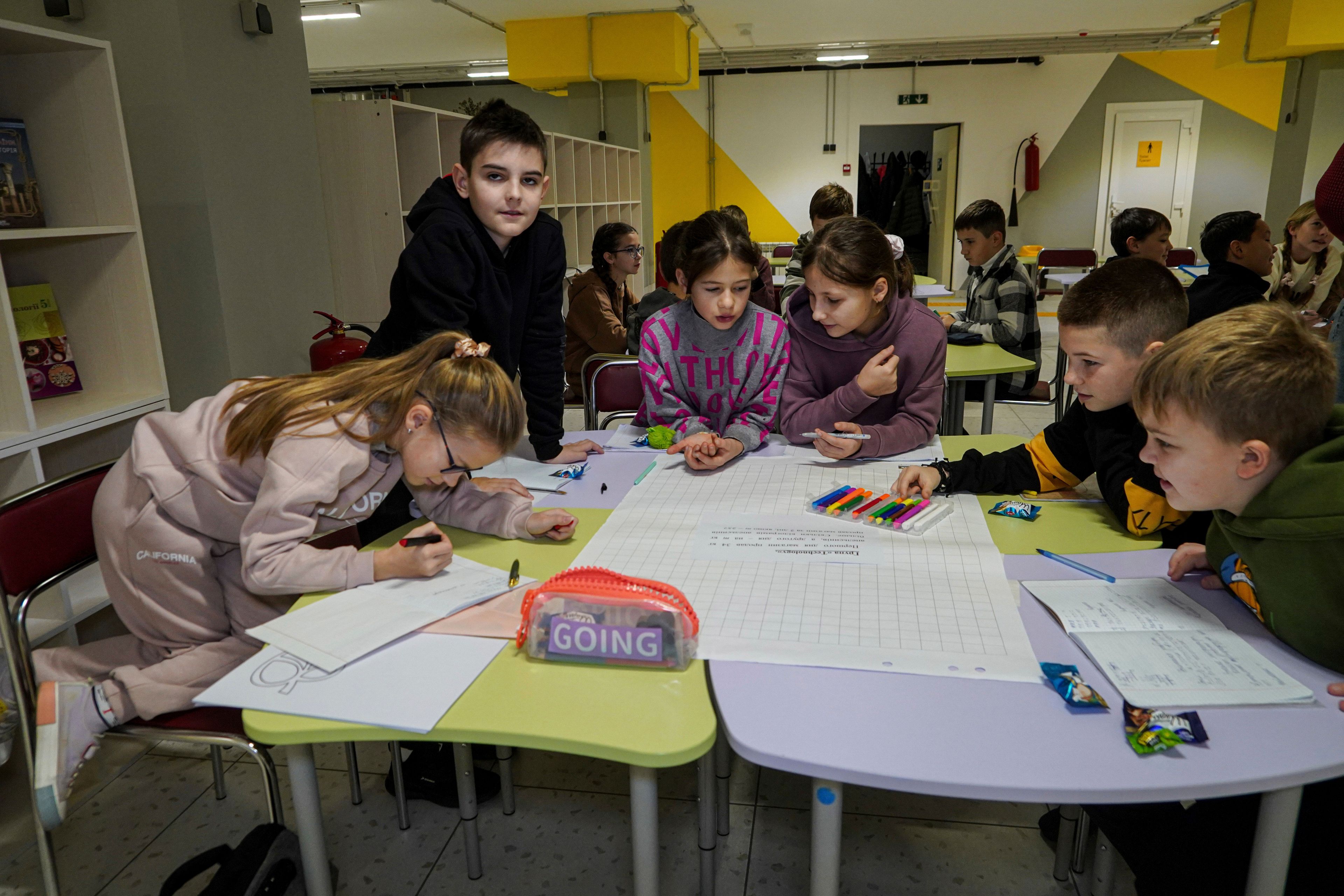 Children study in an underground school in Liubotyn, Kharkiv region, Ukraine, Monday Nov. 11, 2024. (AP Photo/Andrii Marienko)