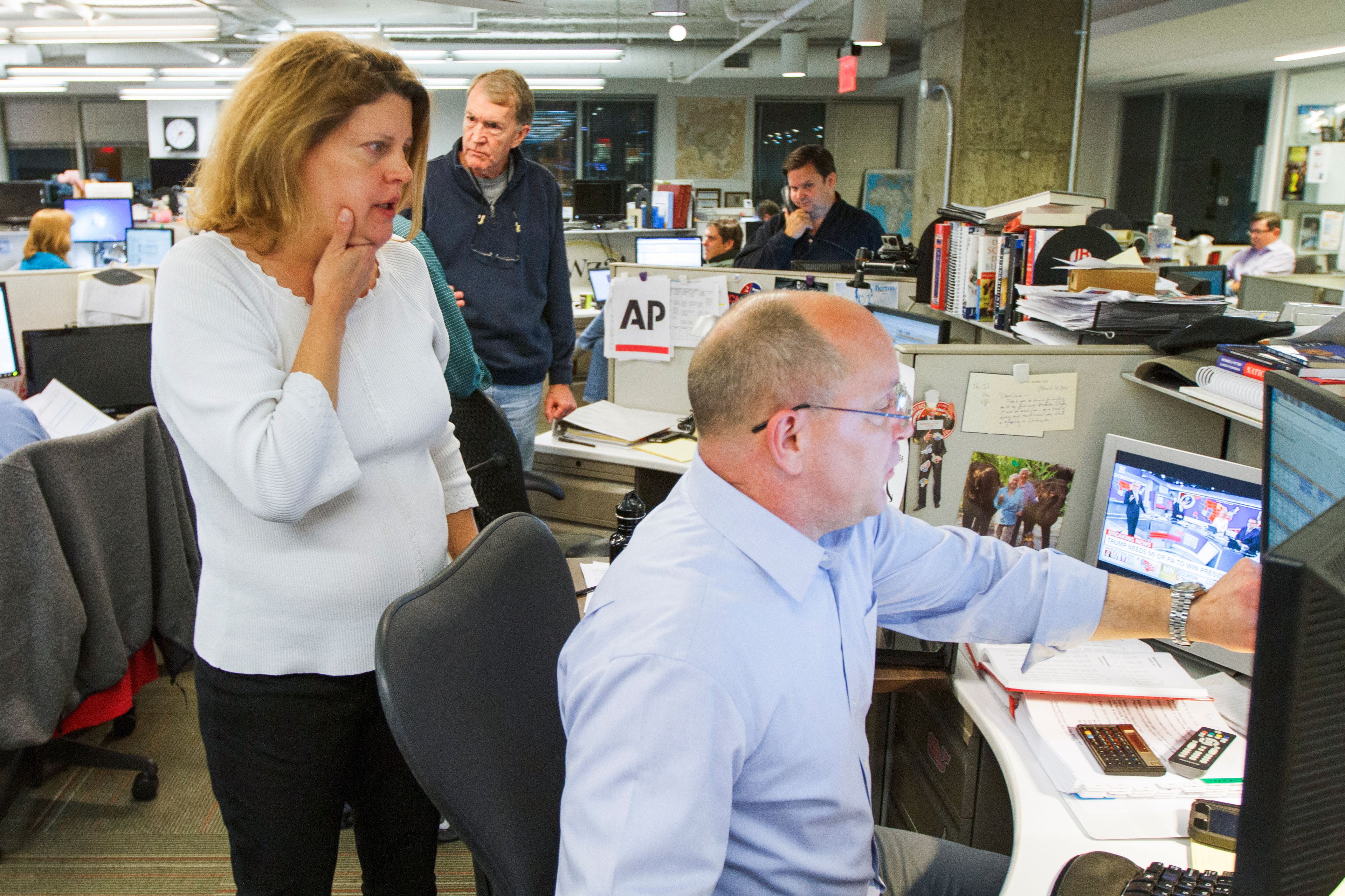 FILE - Then-Associated Press Washington bureau chief Sally Buzbee, talks with Stephen Ohlemacher, who in 2020 is the decision desk editor, in the early morning hours of Wednesday, Nov. 9, 2016, at the Washington bureau of The Associated Press during election night. (AP Photo/Jon Elswick, File)