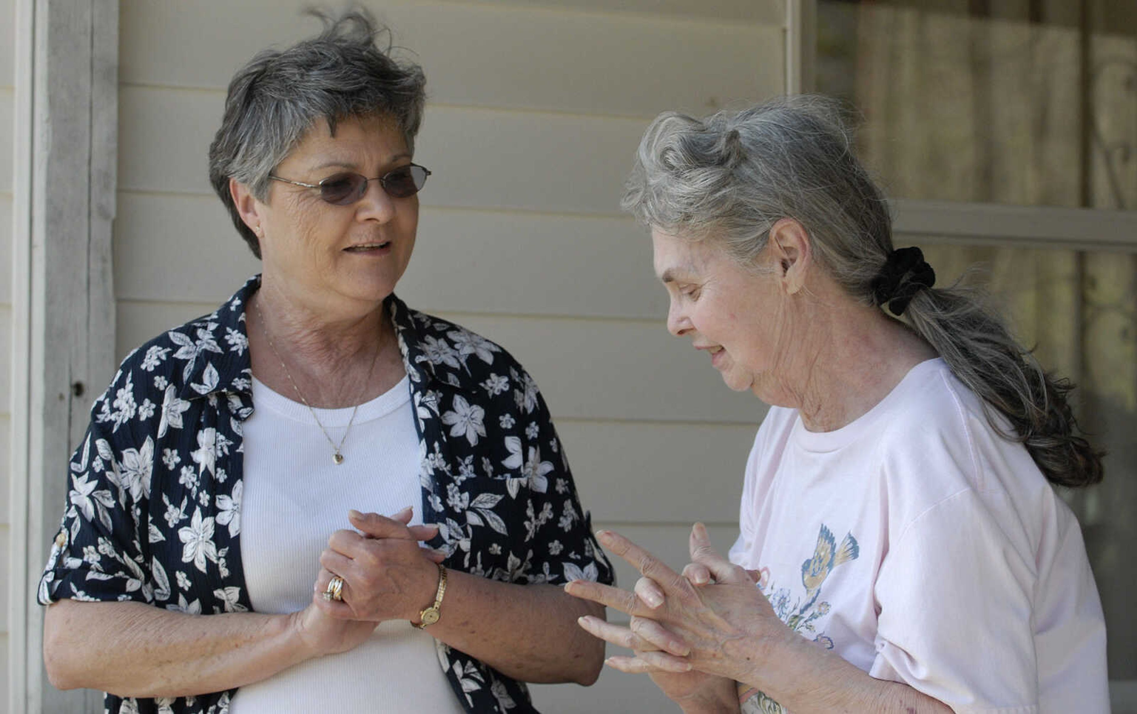 LAURA SIMON~lsimon@semissourian.com
Darlene Tilley-Allen with the Salvation Army offers her assistance to homeowner Delores Tackett during a natural cover fire that started next to Tackett's home on Cissus Lane near Neelys Landing Sunday, April 3, 2011. Firefighters from Cape Girardeau, Perry, Scott, and Bollinger Counties contained the blaze that ravaged 50 acres of land.