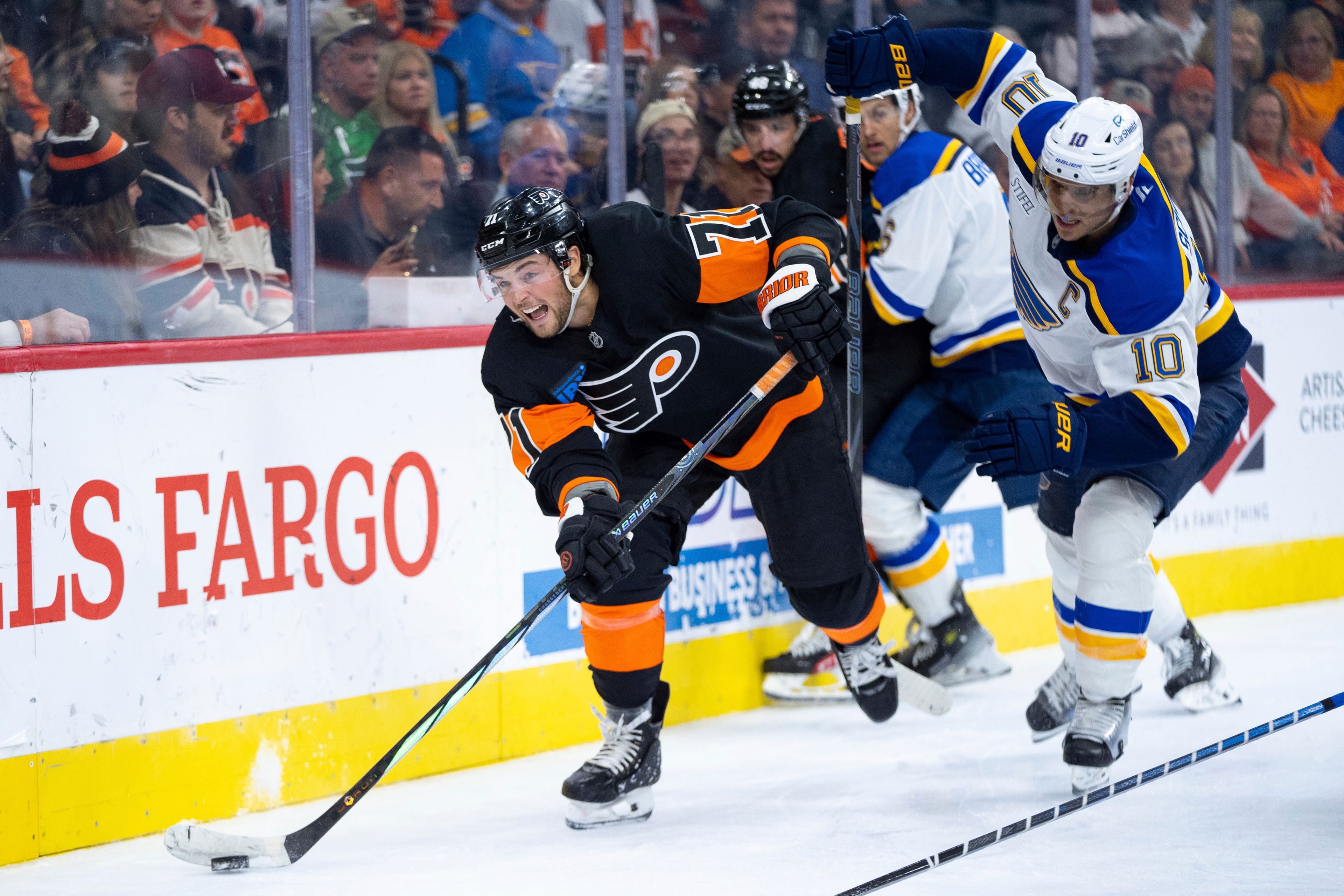 Philadelphia Flyers' Tyson Foerster, left, skates the puck away from St Louis Blues' Brayden Schenn, right, during the second period of an NHL hockey game, Thursday, Oct. 31, 2024, in Philadelphia. (AP Photo/Chris Szagola)