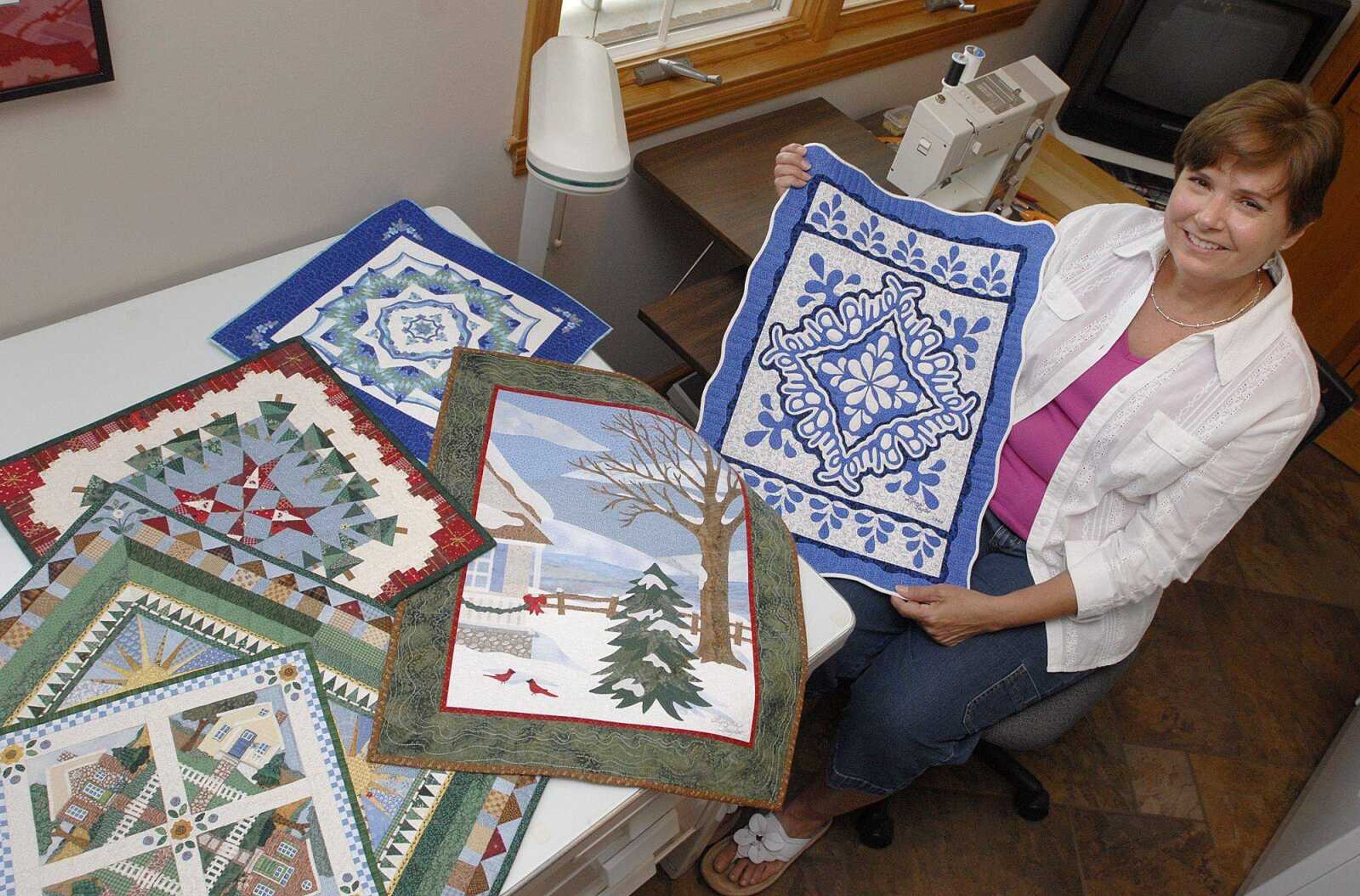 Lynn Taylor shows some of her quilts inside her sewing room June 8. Taylor recently won best in show at the prestigious American Quilter's Society Show. (Laura Simon)