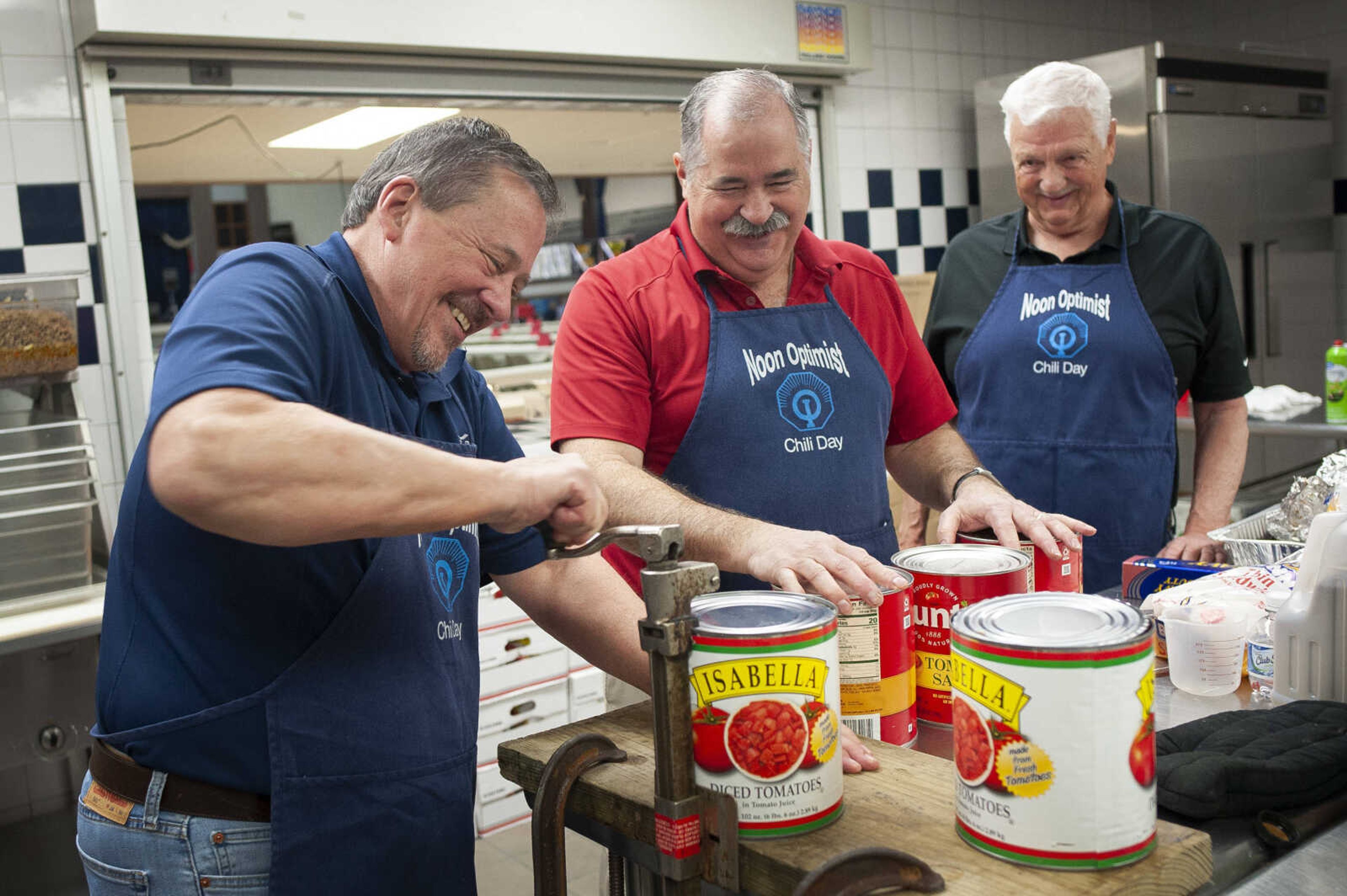 Cape Noon Optimist Club president Virgil Jones of Cape Girardeau opens a can of diced tomatoes while sharing a moment with fellow members Frank Glueck of New Hamburg, Missouri, (middle) and Dave Johnson of Cape Girardeau (right) while making chili before the club's 36th annual Chili Day on Wednesday, March 4, 2020, at the A.C. Brase Arena Building in Cape Girardeau.