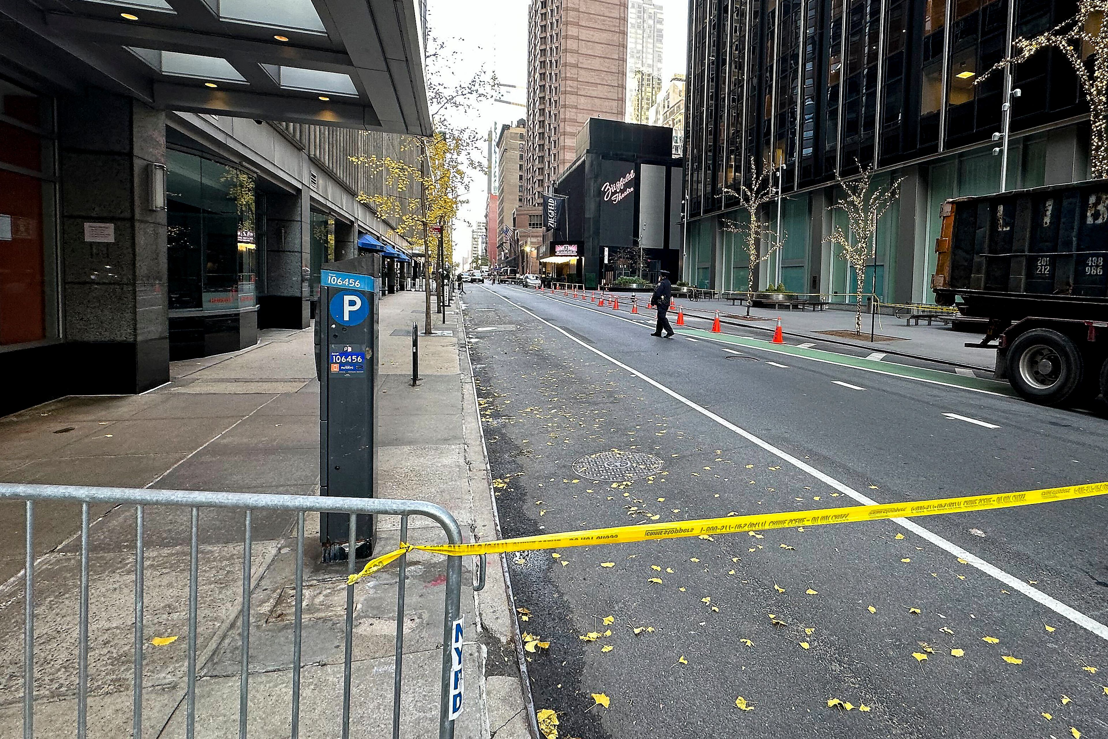 A New York police officer walks outside a hotel in midtown Manhattan where Brian Thompson, the CEO of UnitedHealthcare, was fatally shot Wednesday, Wednesday, Dec. 4, 2024, in New York. (AP Photo/Joe Frederick)