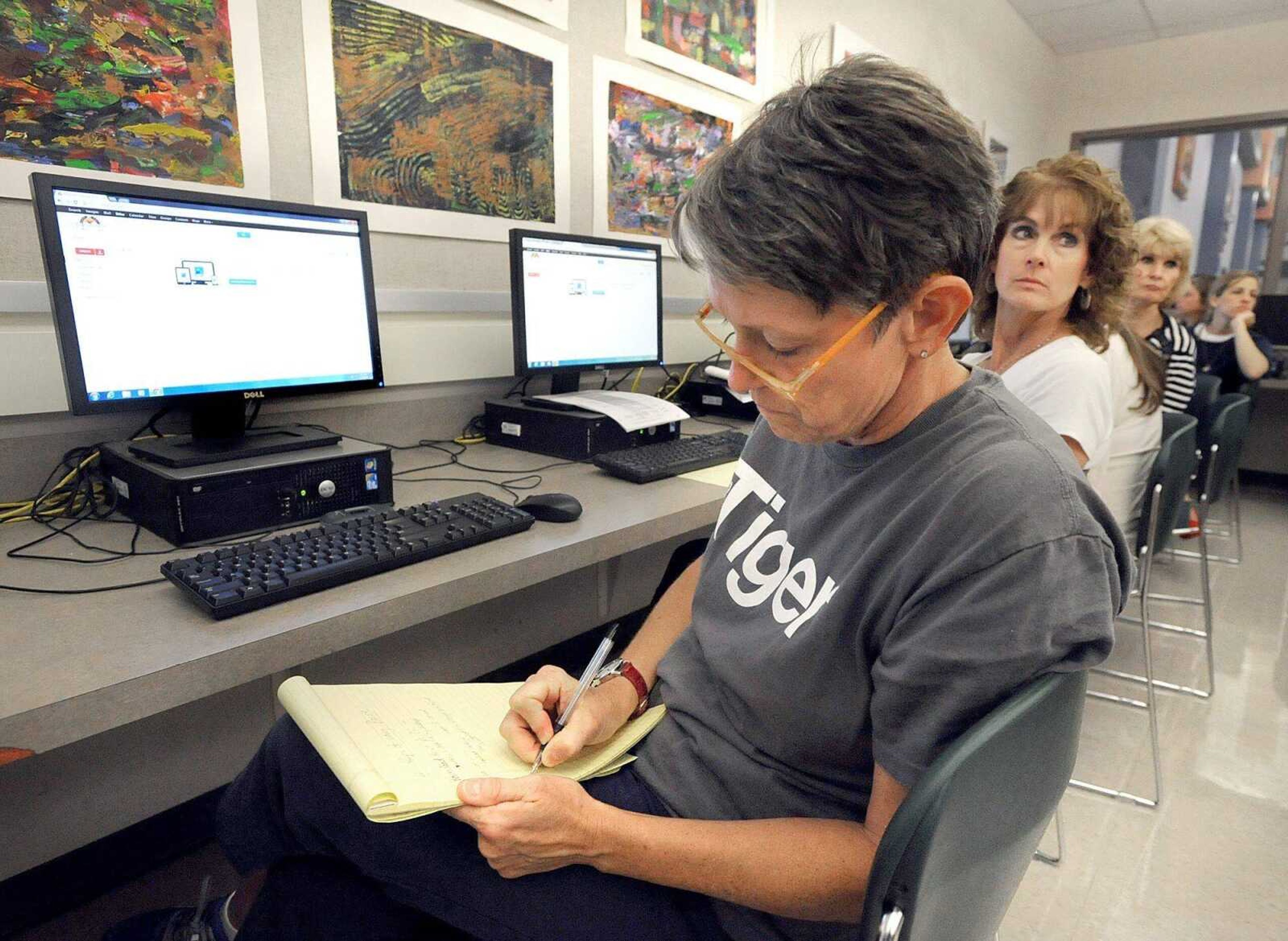 Cape Central HIgh School English teacher Crystal Cerny takes notes during the teachers technology training from Ron Farrow, instructional technologist, Friday, June 28, 2013, inside the high school library. Part of the training included the use of Moodle, Modular Object-Oriented Dynamic Learning Environment.
(Laura Simon)