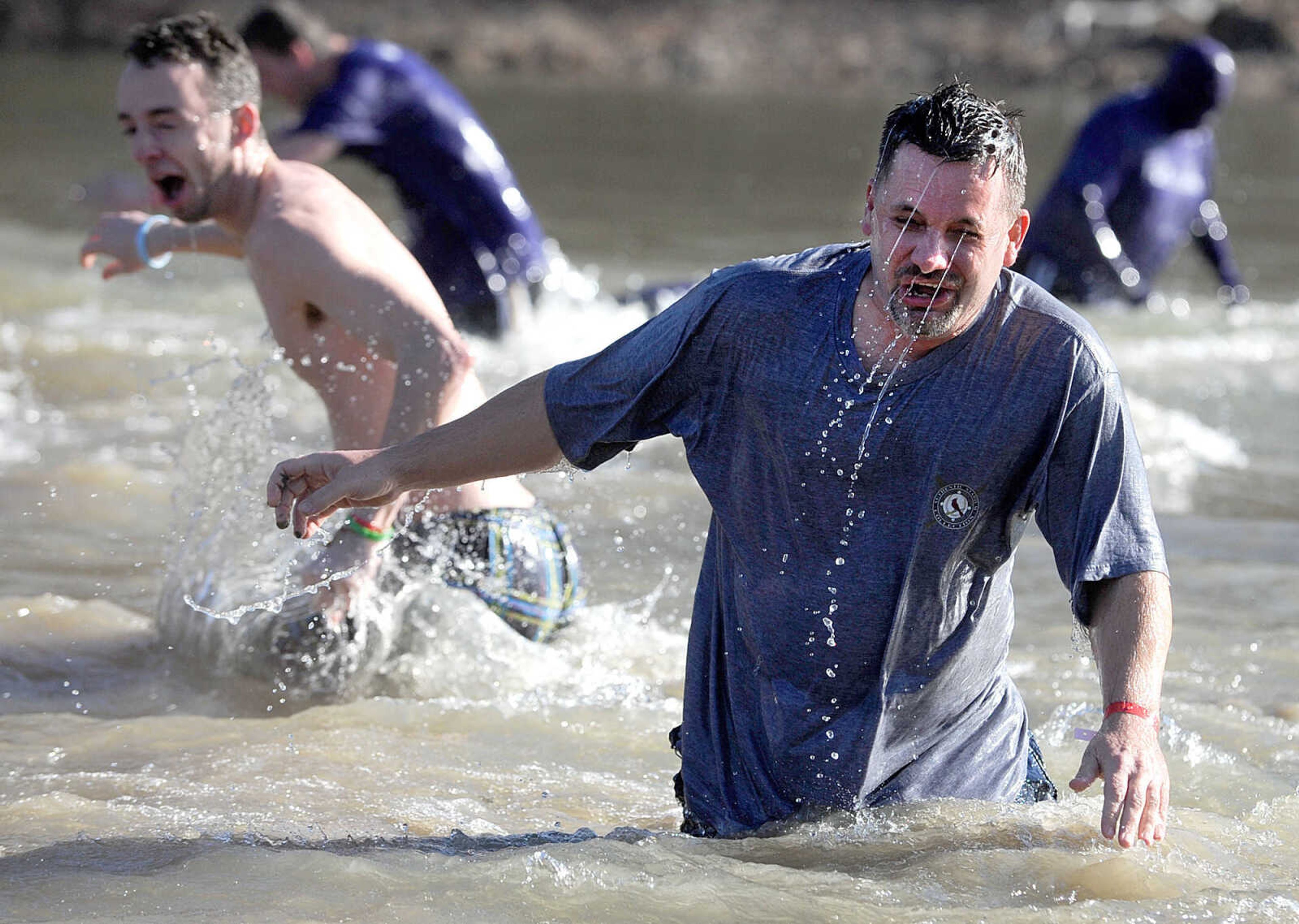 LAURA SIMON ~ lsimon@semissourian.com
People plunge into the cold waters of Lake Boutin Saturday afternoon, Feb. 2, 2013 during the Polar Plunge at Trail of Tears State Park. Thirty-six teams totaling 291 people took the annual plunge that benefits Special Olympics Missouri.