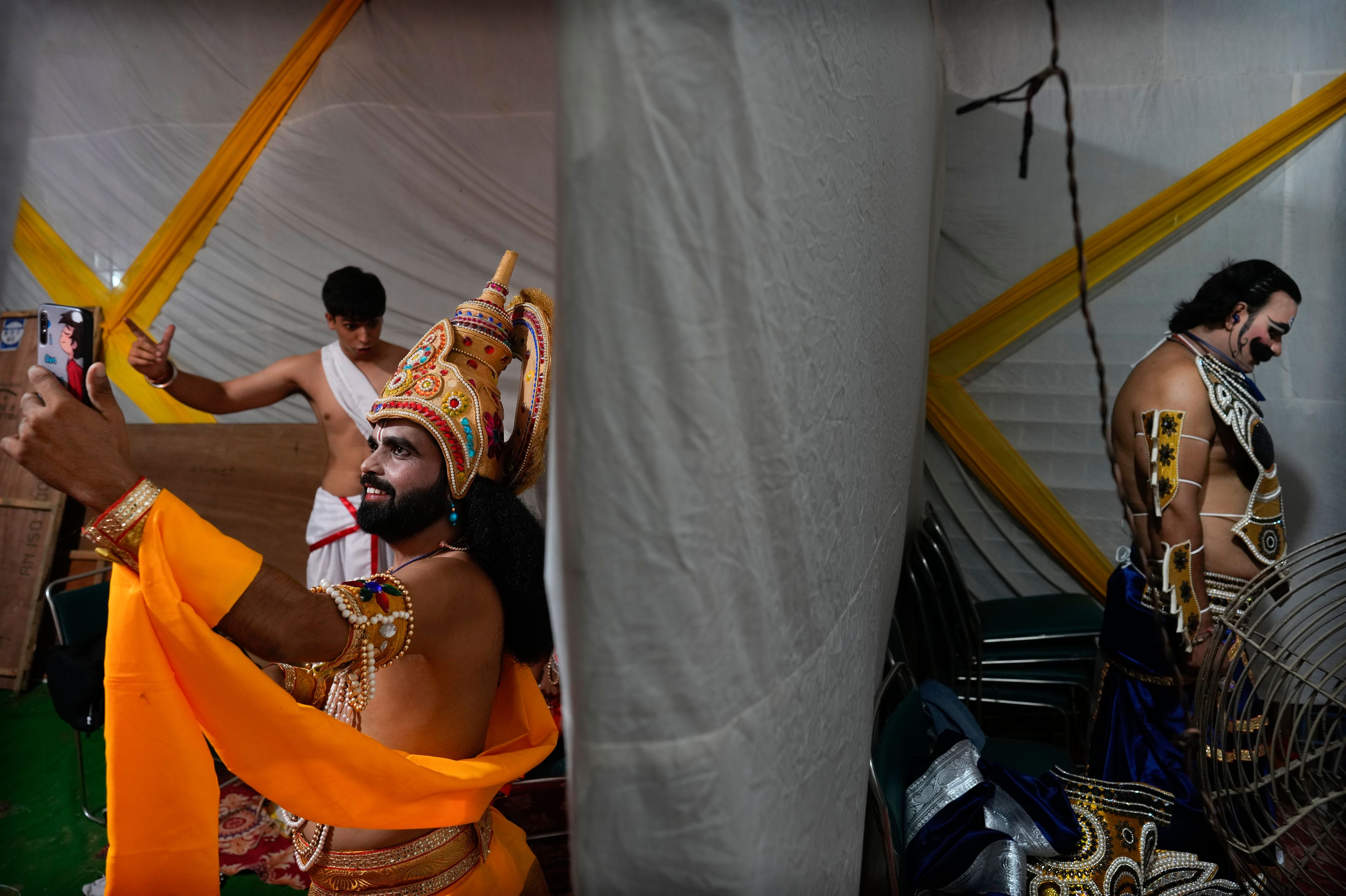 Actors rehearse their lines backstage before the start of Ramleela, a dramatic folk re-enactment of the life of Hindu god Rama according to the ancient Hindu epic Ramayana, in New Delhi, India, Saturday, Oct. 5, 2024. (AP Photo/Manish Swarup)