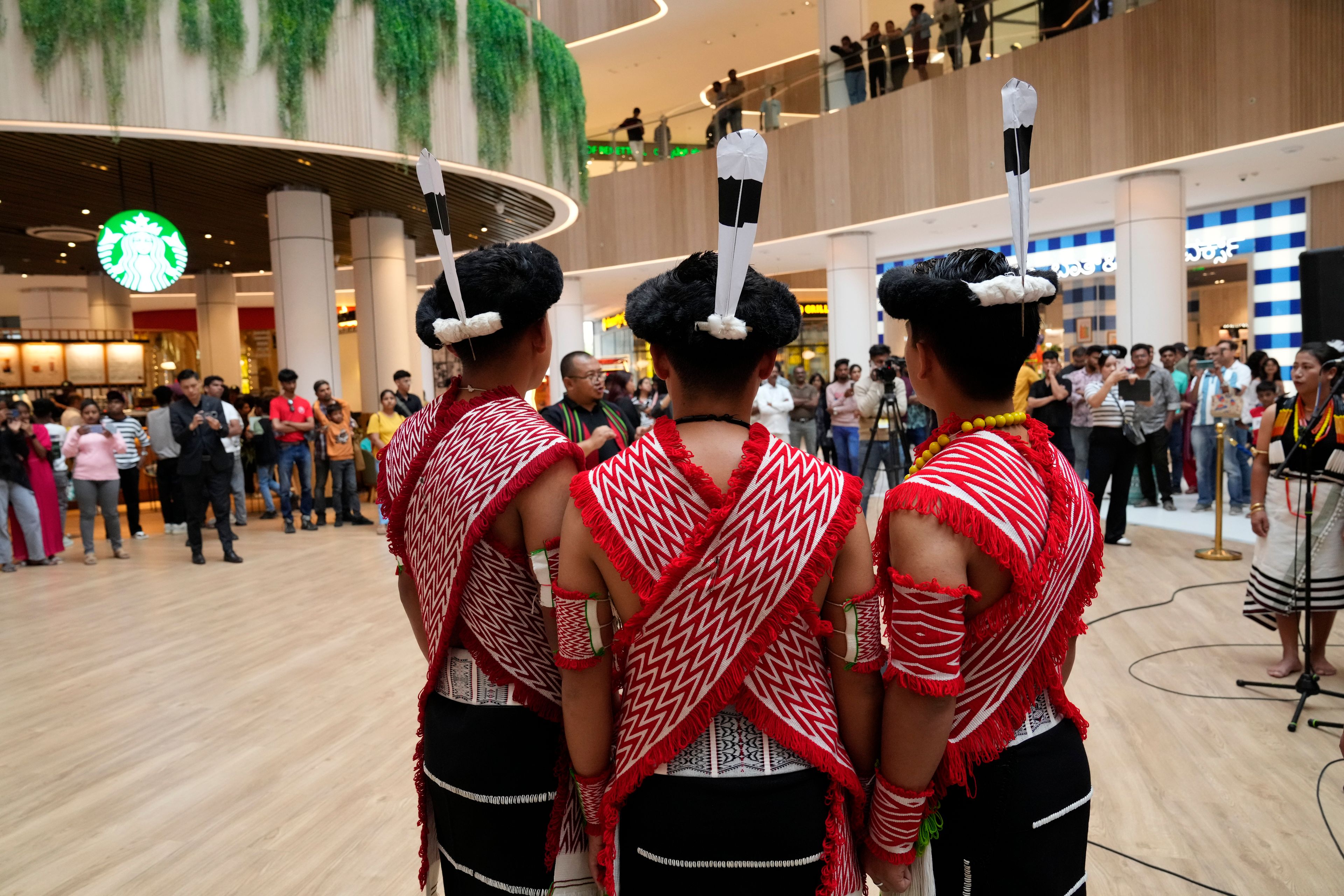 Artists from India's northeastern state of Nagaland wearing traditional attire perform at a shopping mall during the two-day Brillante Piano Festival in Bengaluru, India, Sunday, Sept. 29, 2024. (AP Photo/Aijaz Rahi)