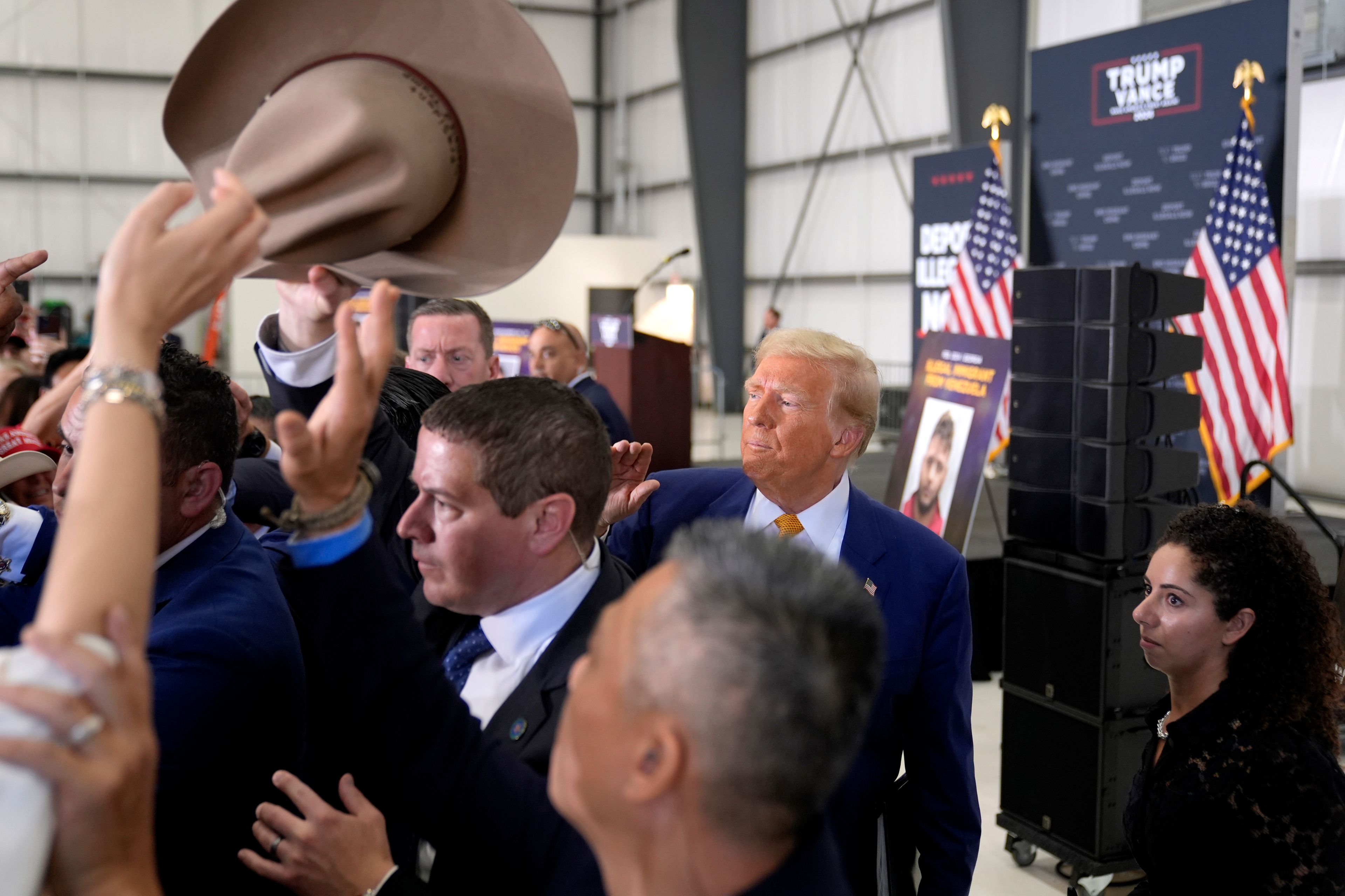 Republican presidential nominee former President Donald Trump, second right, greets attendees as he departs a news conference at Austin-Bergstrom International Airport, Friday, Oct. 25, 2024, in Austin, Texas. (AP Photo/Alex Brandon)