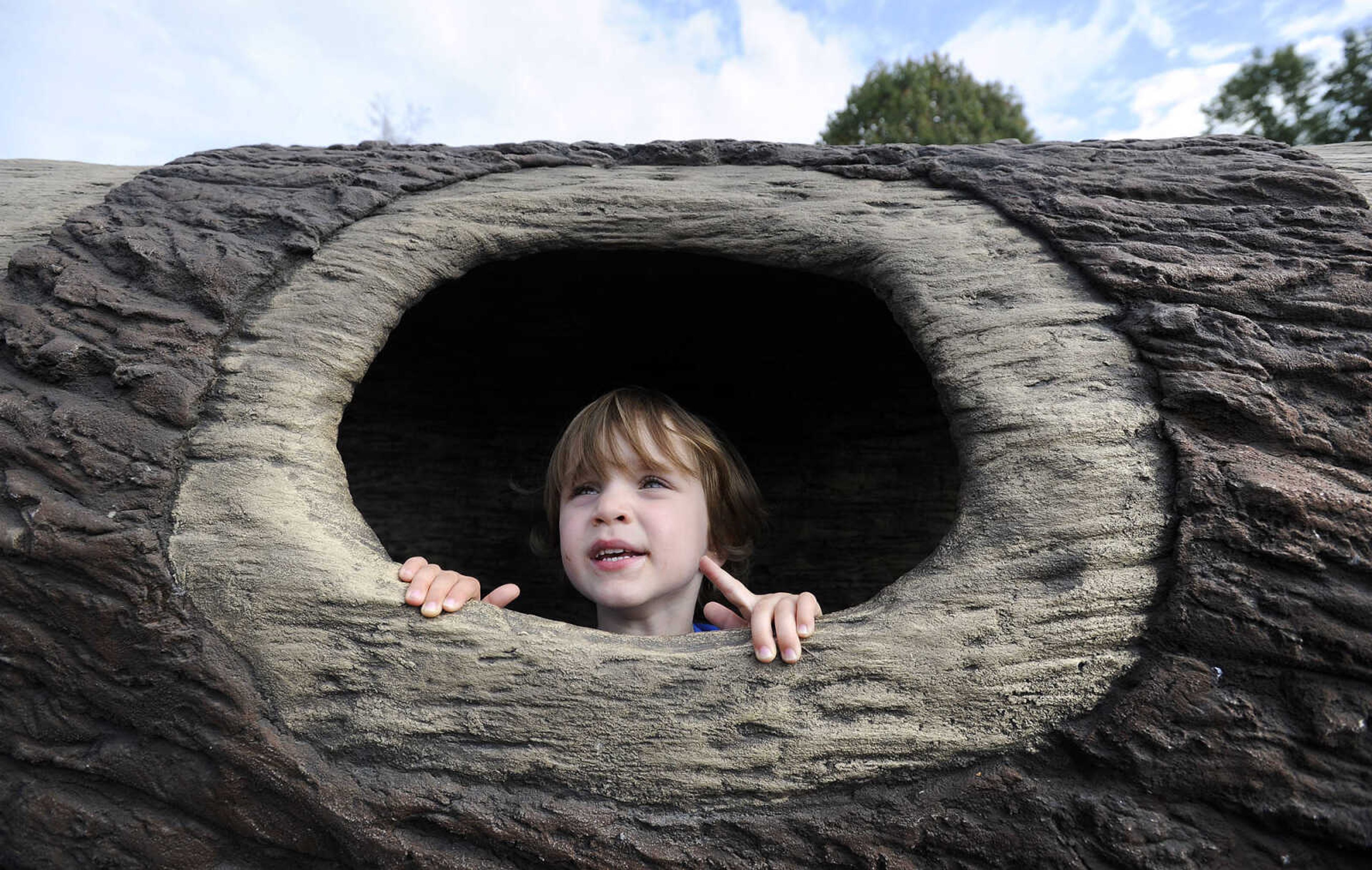 LAURA SIMON ~ lsimon@semissourian.com

Sean Antill peaks out from whole in a tree tunnel at the new playground at Capaha Park, Friday, Oct. 23, 2015, in Cape Girardeau.