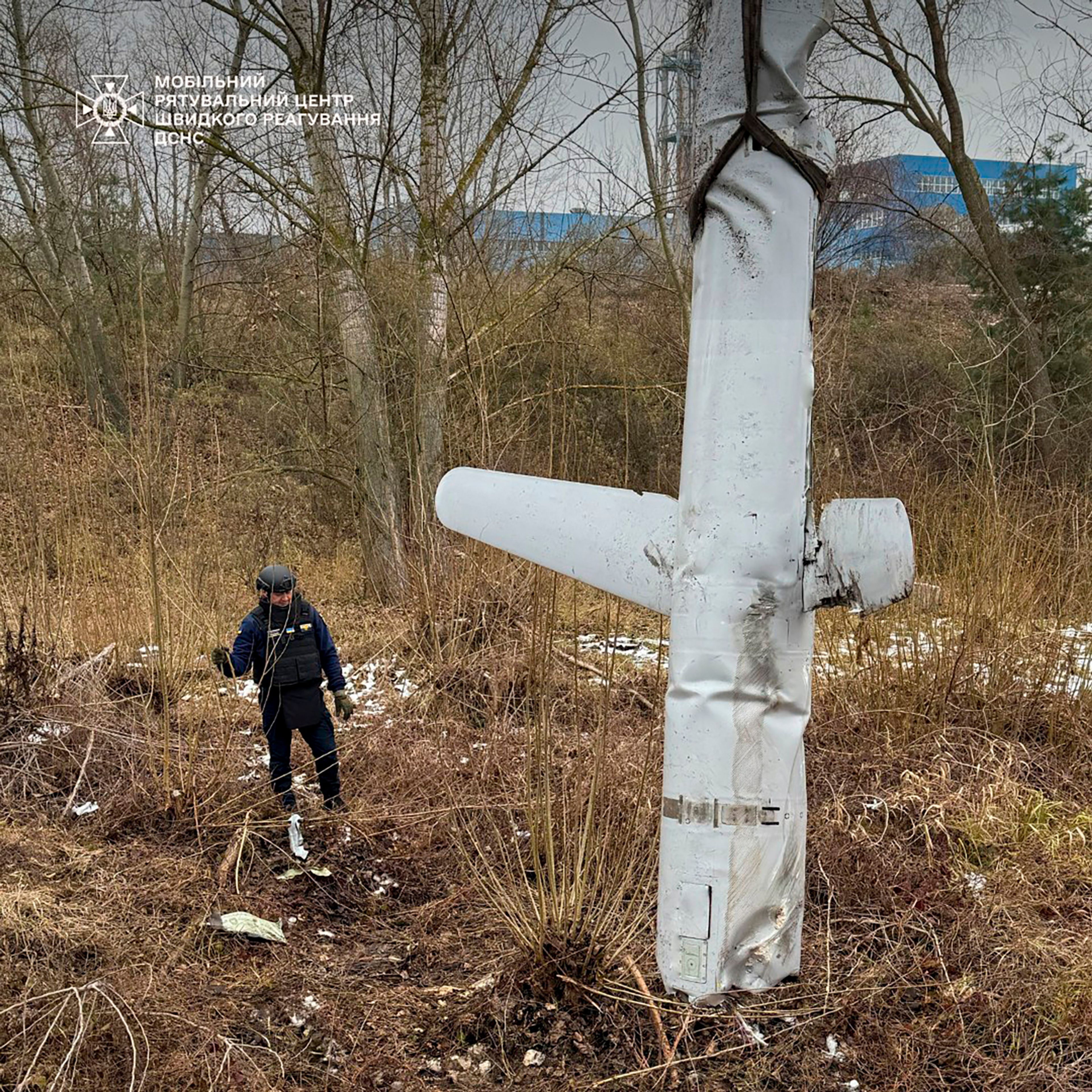 In this photo provided by the Ukrainian Emergency Service, pyrotechnists examine an X-55 Russian cruise missile that was shot down in Kyiv, Ukraine, Thursday, Nov. 28, 2024. (Ukrainian Emergency Service via AP)