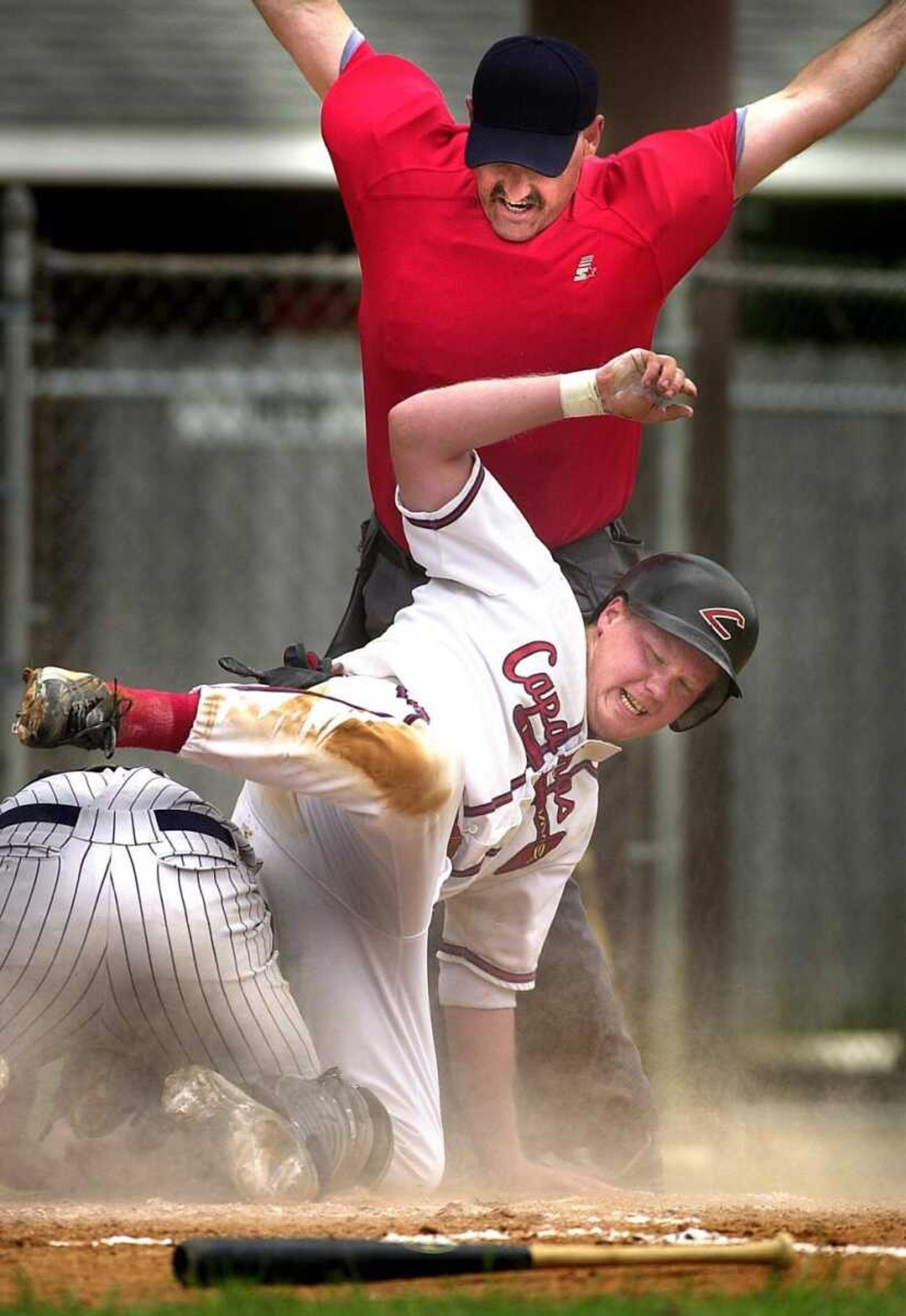 (MATTHEW APGAR &#149; photos@semissourian.com)  Tom Bolen of the Capahas collided with Riverdog's catcher Greg Craft in the bottom of the forth inning with one out.  The Capahas won their first game of their Sunday doubleheader with a score of 2-1.