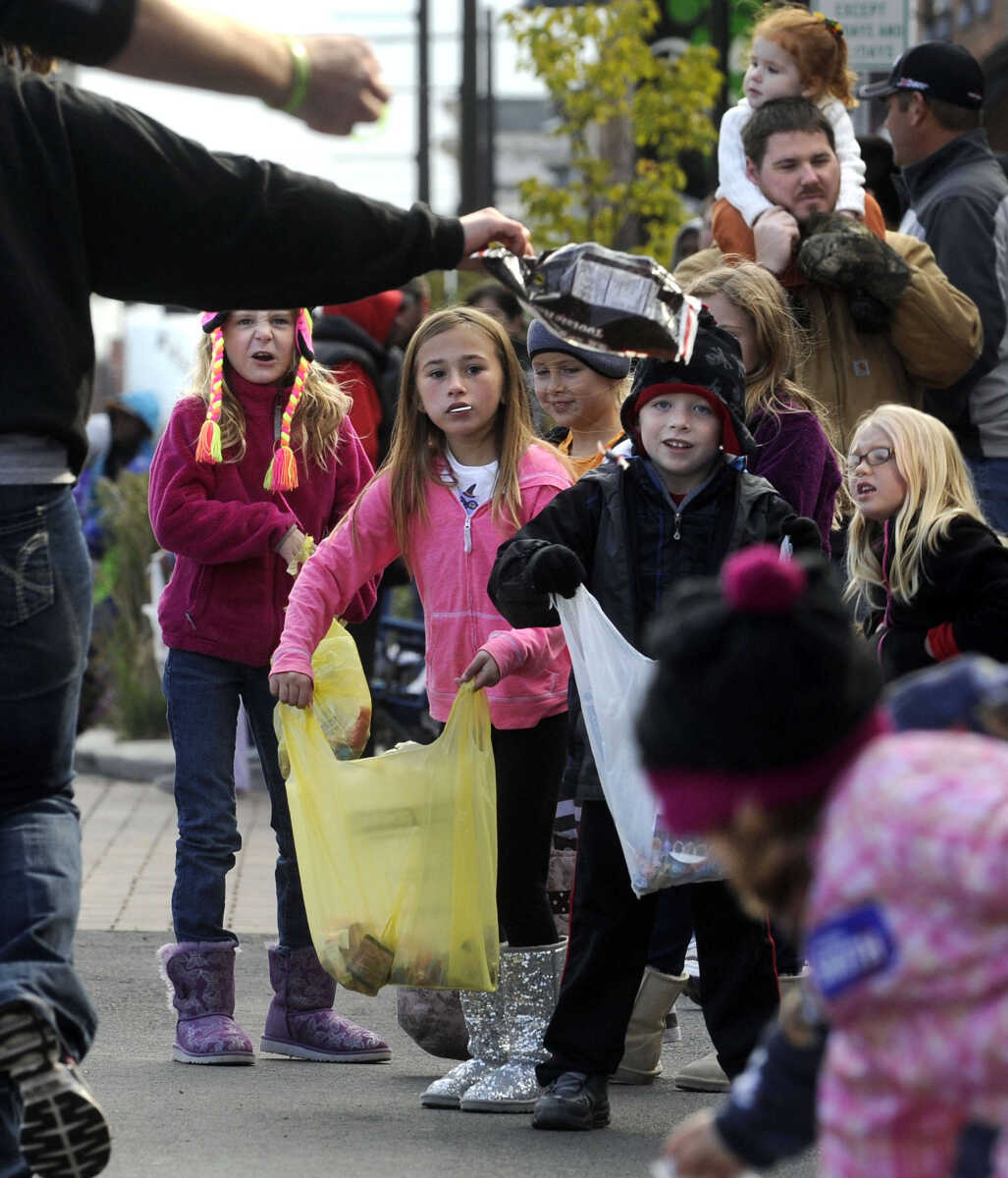 FRED LYNCH ~ flynch@semissourian.com
Youngsters solicit candy during the SEMO Homecoming parade Saturday, Oct. 26, 2013 on Broadway in Cape Girardeau. More pictures are in a gallery at semissourian.com.