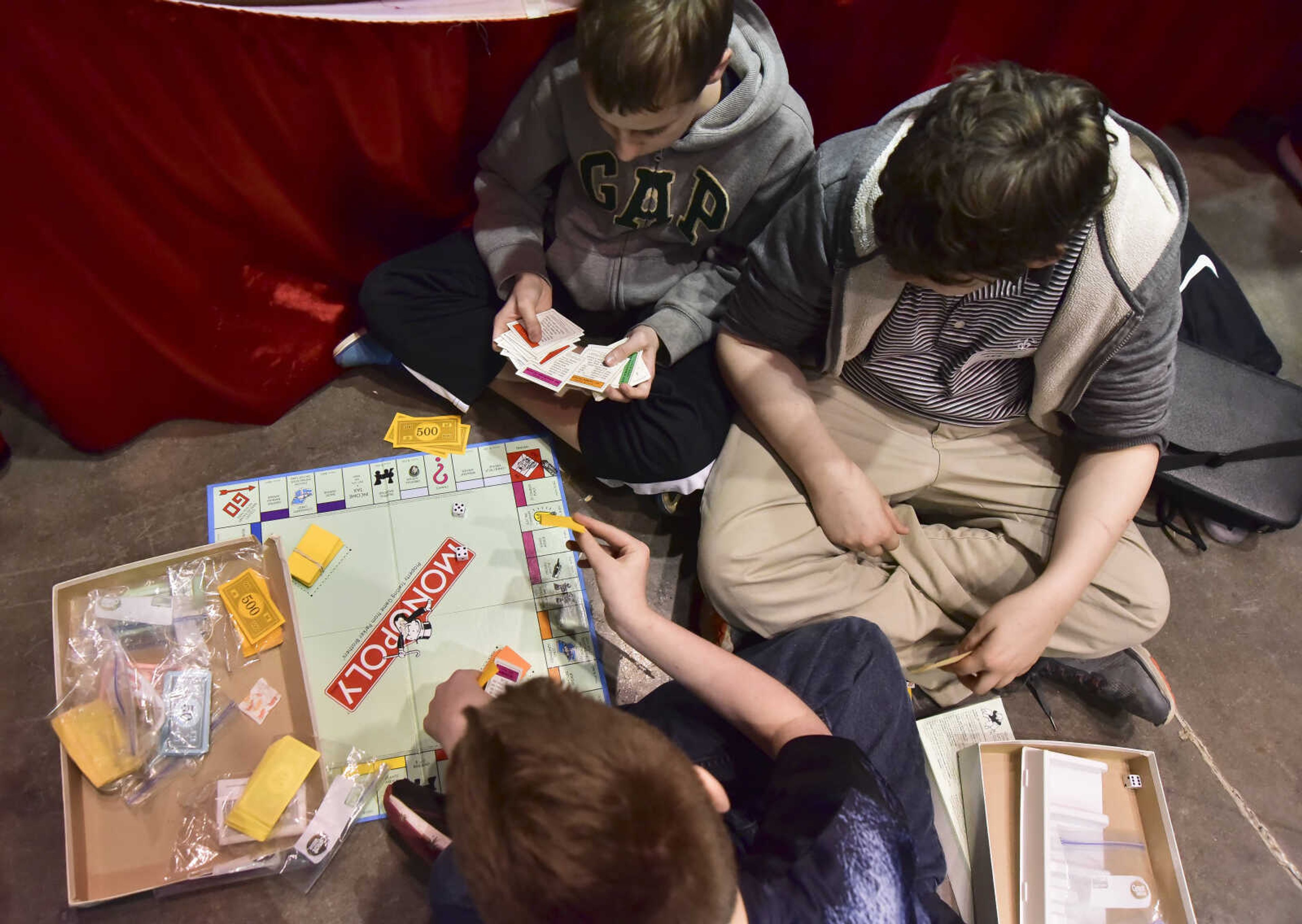 From left, Lucas Meier, Conner Marshall and Connor Bainter play Monopoly during the Southeast Missouri Regional Science Fair Tuesday, March 7, 2017 at the Show Me Center in Cape Girardeau.