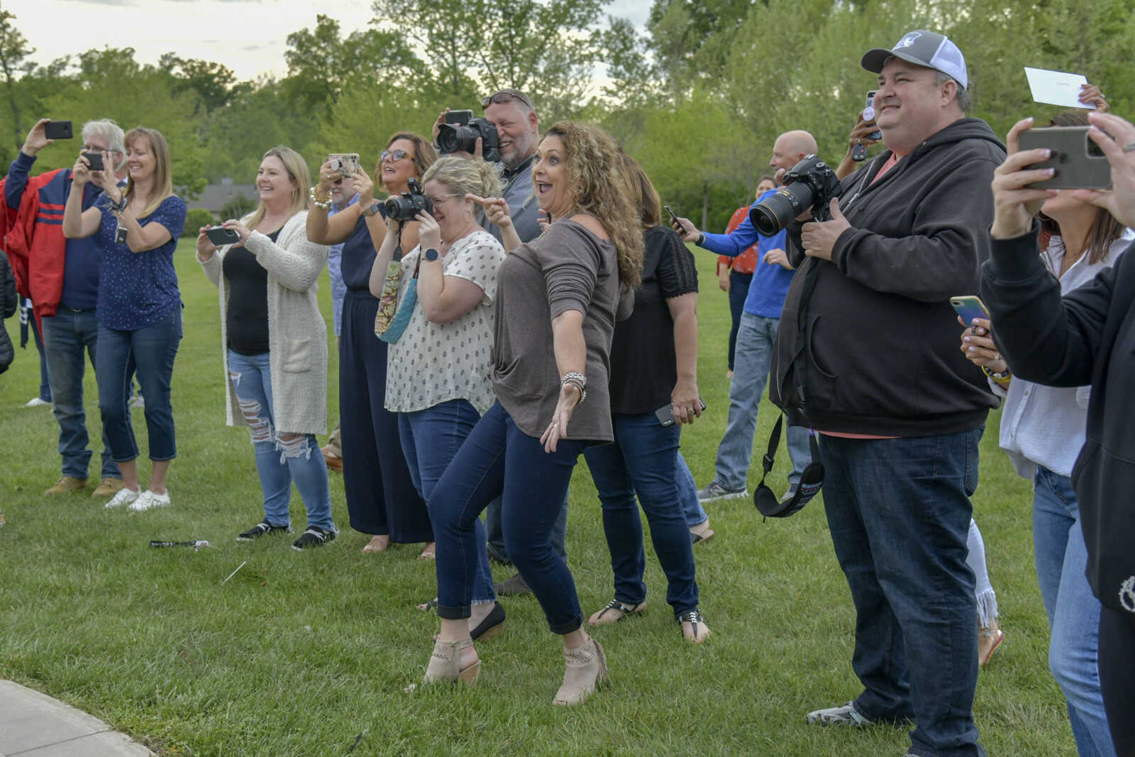 Mother to Leyton Lynn, Jill Lynn, center, tries to make the students smile while they pose for a picture during a pre-prom event at the Dalhousie Golf Club in Cape Girardeau on Saturday, May 8, 2021.