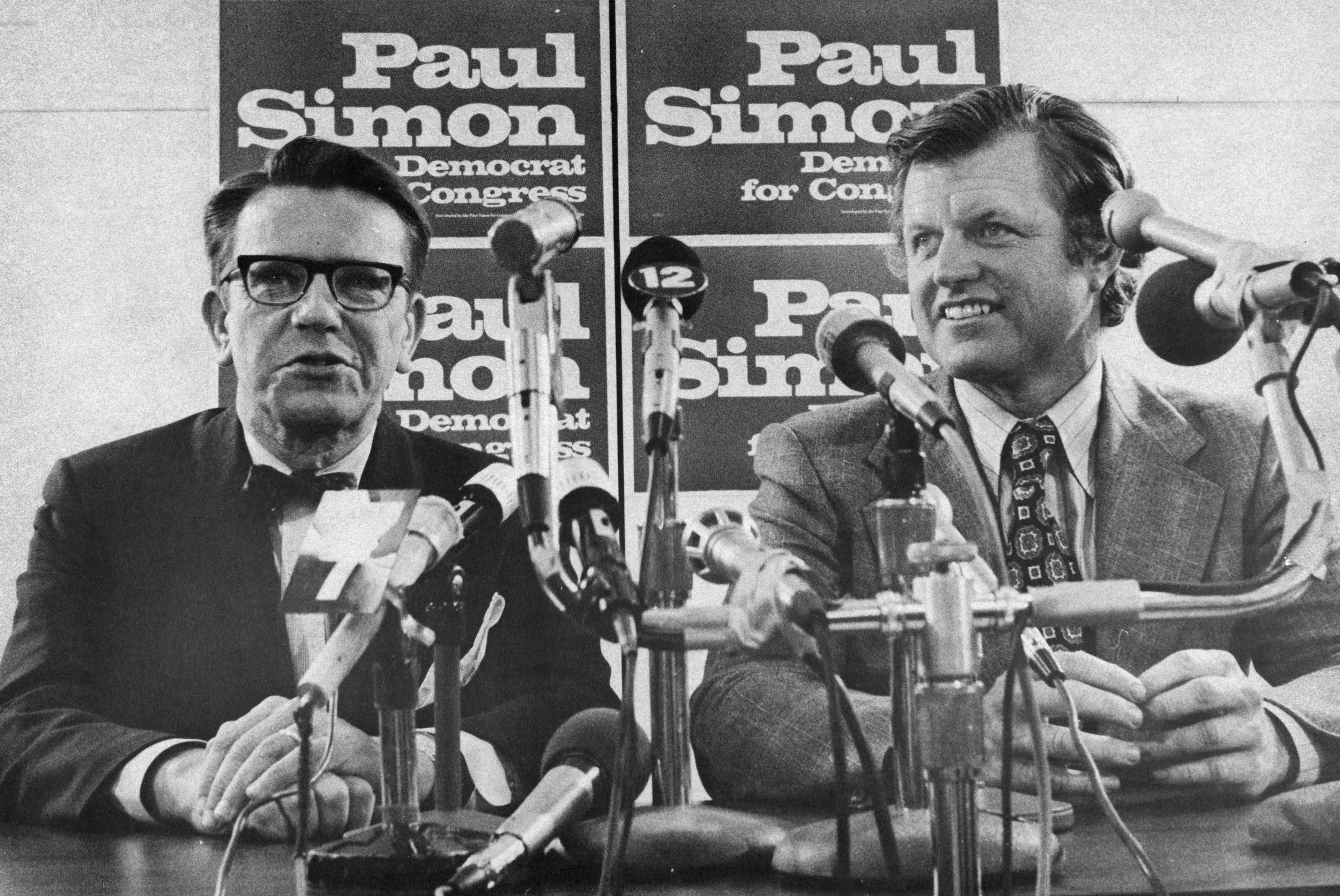 Sen. Edward Kennedy answers reporters' questions during a news conference Friday, Oct. 4, 1974, in Carbondale, Illinois. At left is Democratic Congressional candidate Paul Simon.