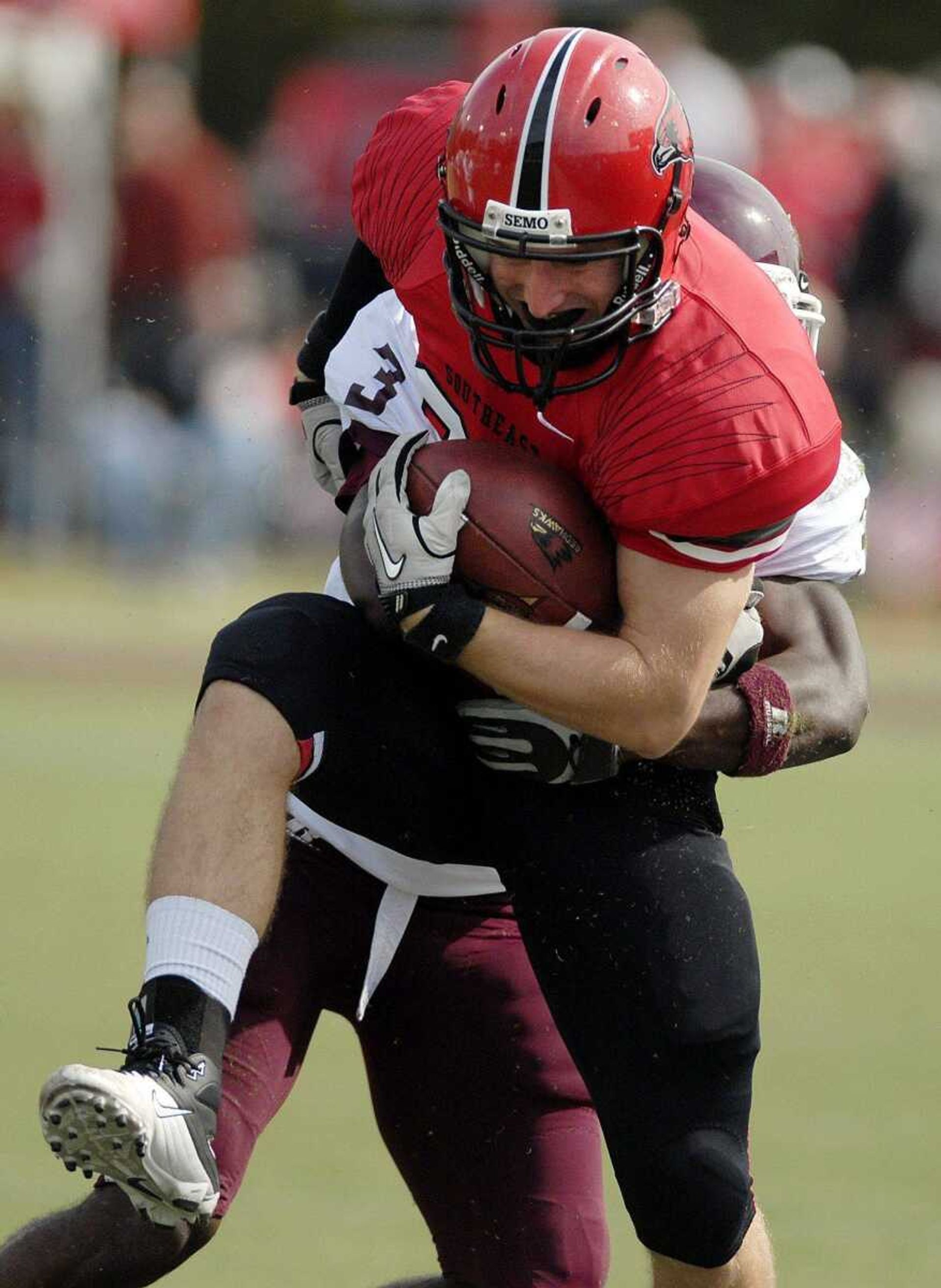 Southeast quarterback Matt Scheible tries to break free from a tackle during the second quarter.