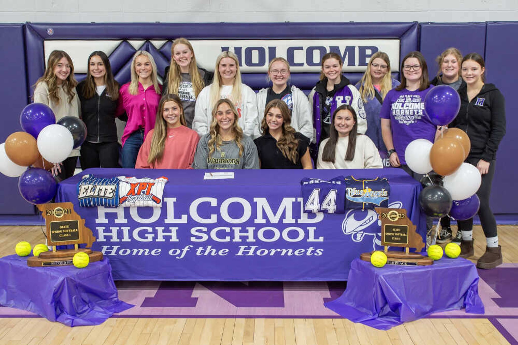 Holcomb High School Lady Hornets' shortstop and Tri-County Conference Player of the Year Maleigh Lemings (seated, second from left) with members of the Holcomb softball program as she signs to play for East Central Community College.