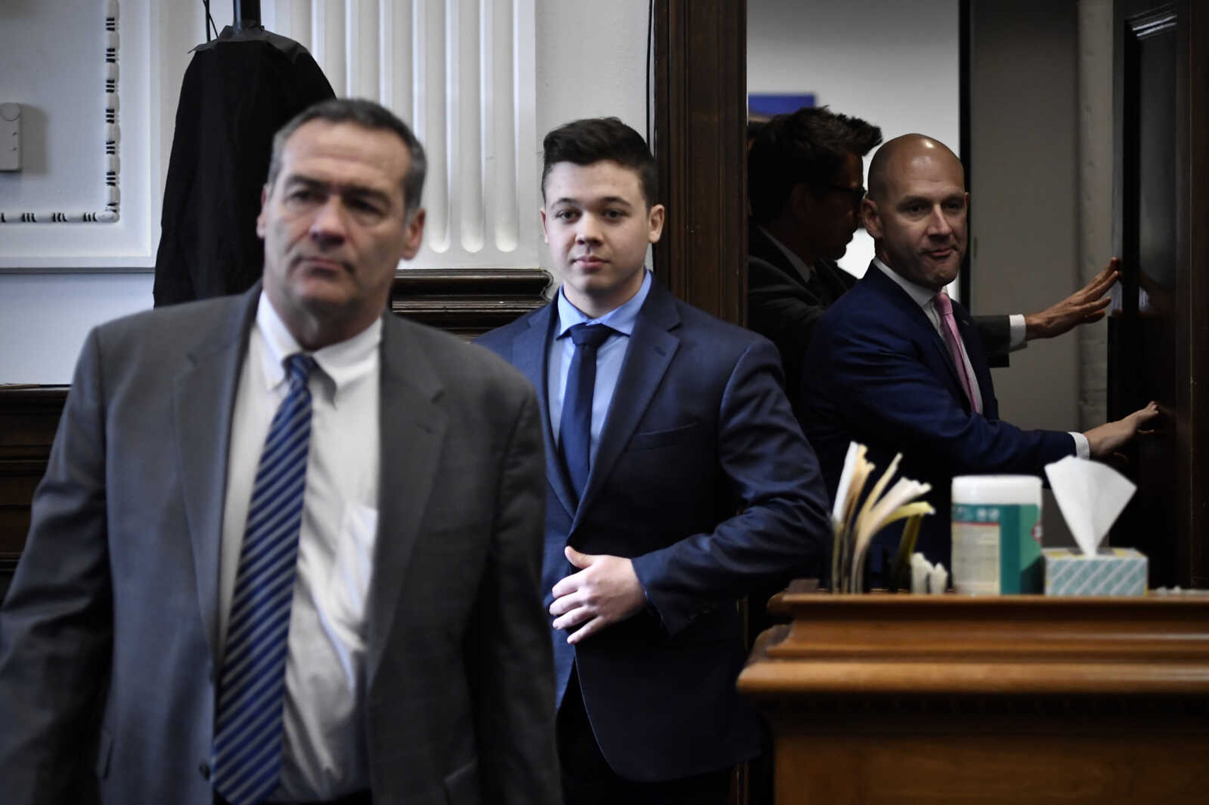 Kyle Rittenhouse, center, enters the courtroom with his attorneys Mark Richards, left, and Corey Chirafisi for a meeting called by Judge Bruce Schroeder at the Kenosha County Courthouse in Kenosha, Wis., on Thursday, Nov. 18, 2021.  (Sean Krajacic/The Kenosha News via AP, Pool)