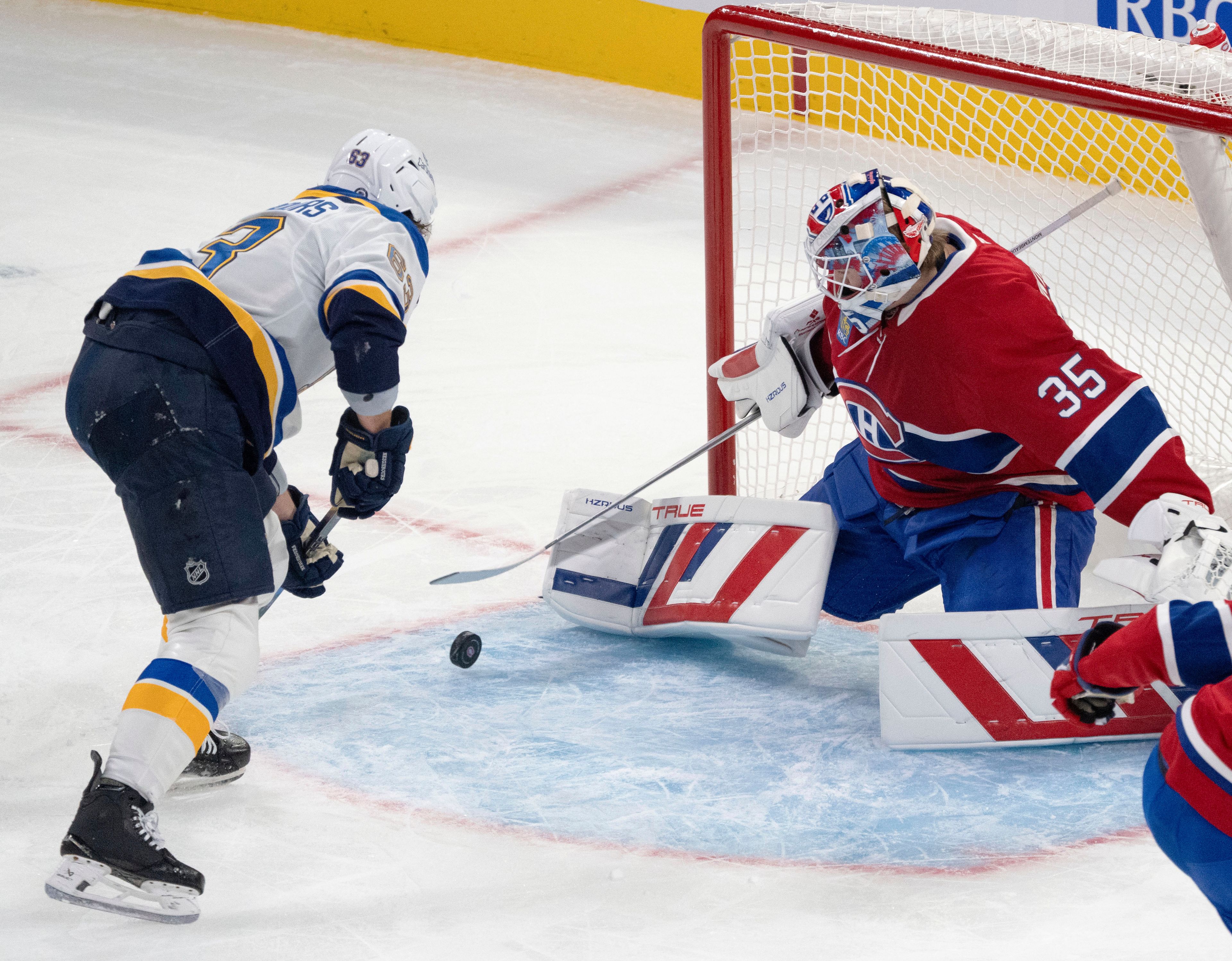 Montreal Canadiens goaltender Sam Montembeault (35) makes the save on St. Louis Blues' Jake Neighbours (63) during first period NHL hockey action Saturday, October 26, 2024 in Montreal. (Ryan Remiorz/The Canadian Press via AP)