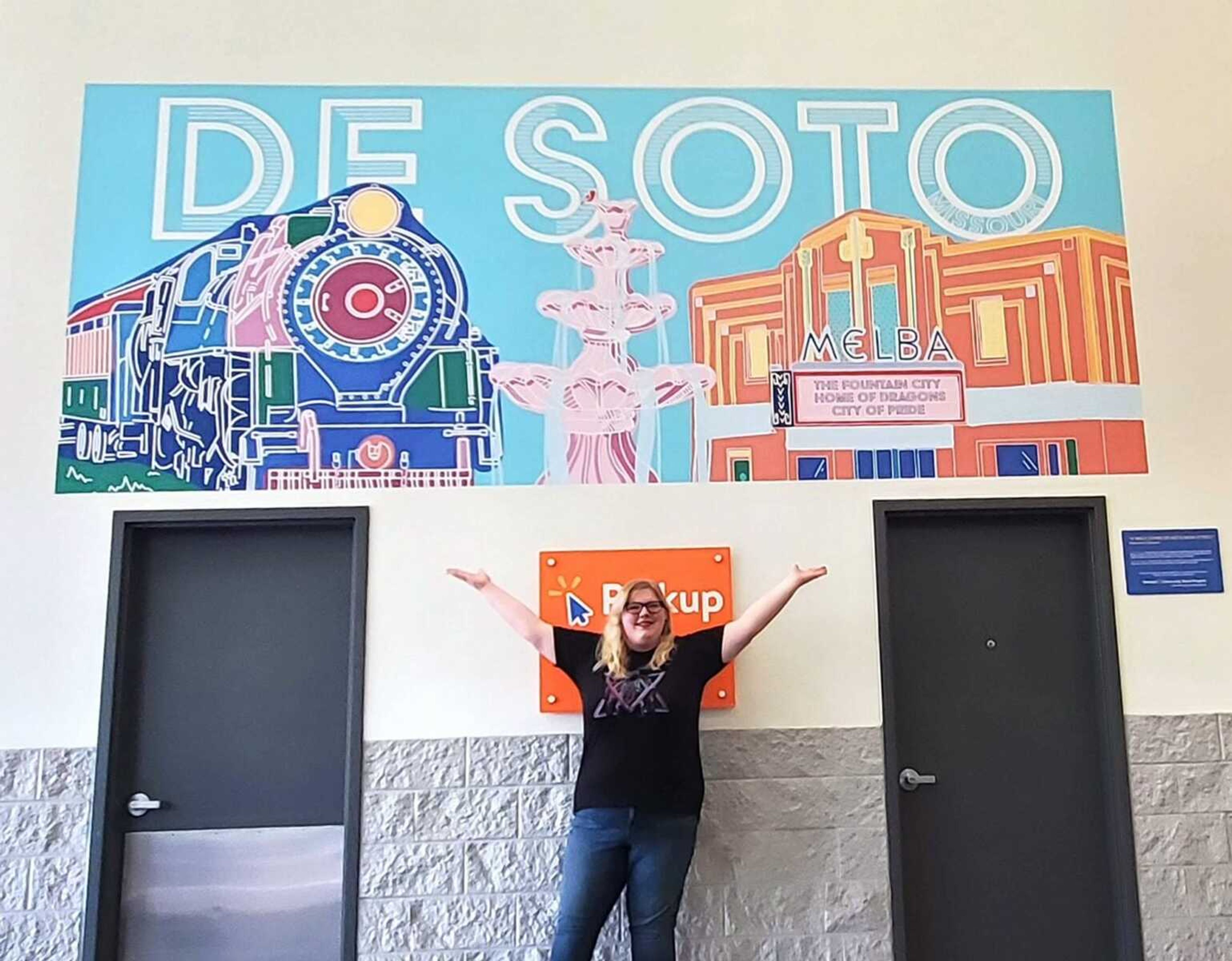 Artist Victoria Lane with one of her murals in her hometown of De Soto, Missouri. She has designed more than a dozen of them and her latest work will represent the City of Jackson.