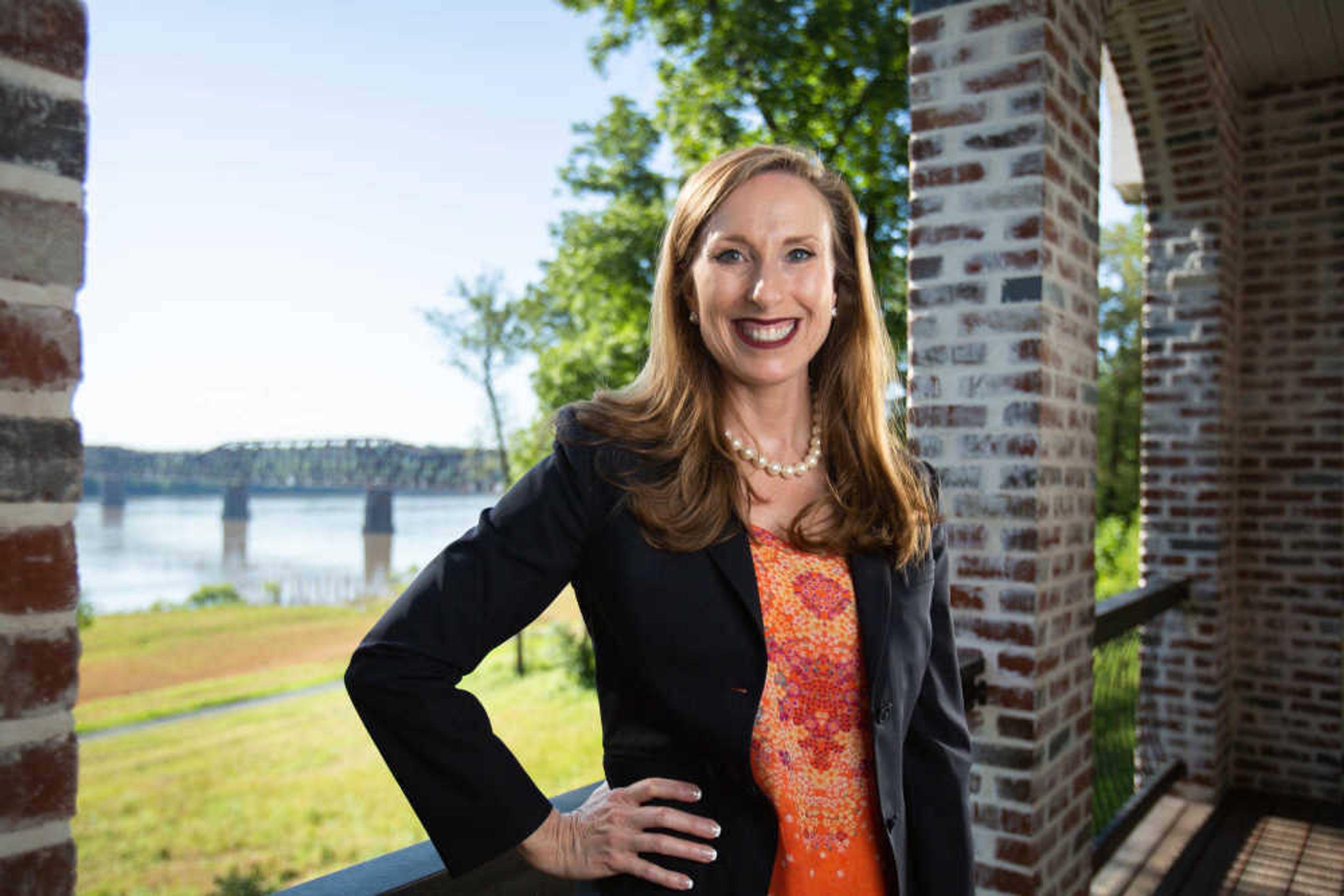 Holly Rehder stands for a photo on the back porch of her home overlooking the Thebes bridge on the Mississippi River.