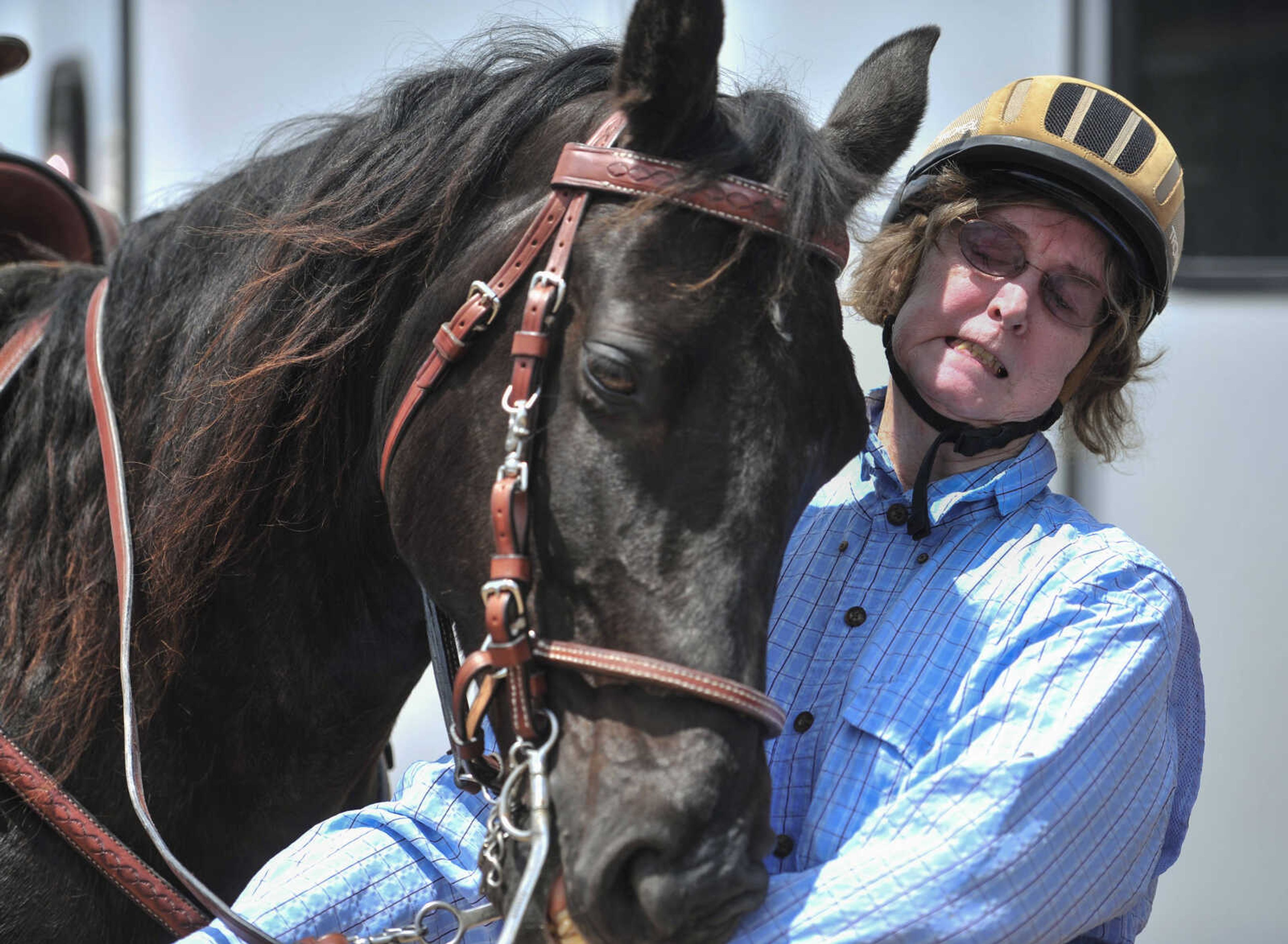 Doris Jost wrangles her horse before saddling up for a trail ride sponsored by Jackson Trail riders June 4, 2017, in Patton, Missouri.