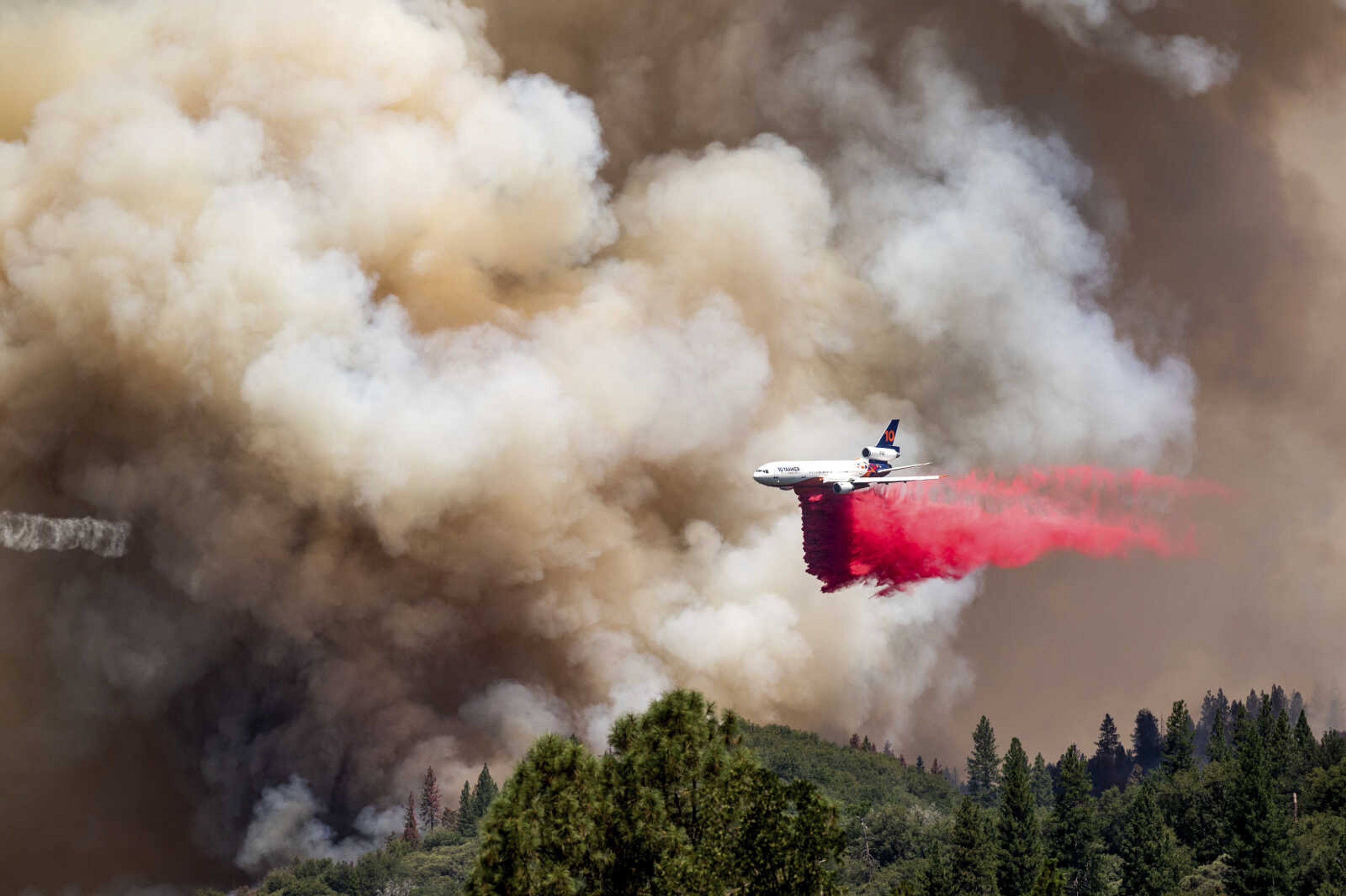 An air tanker drops retardant while trying to stop the Oak Fire from progressing July 24 in Mariposa County, California.