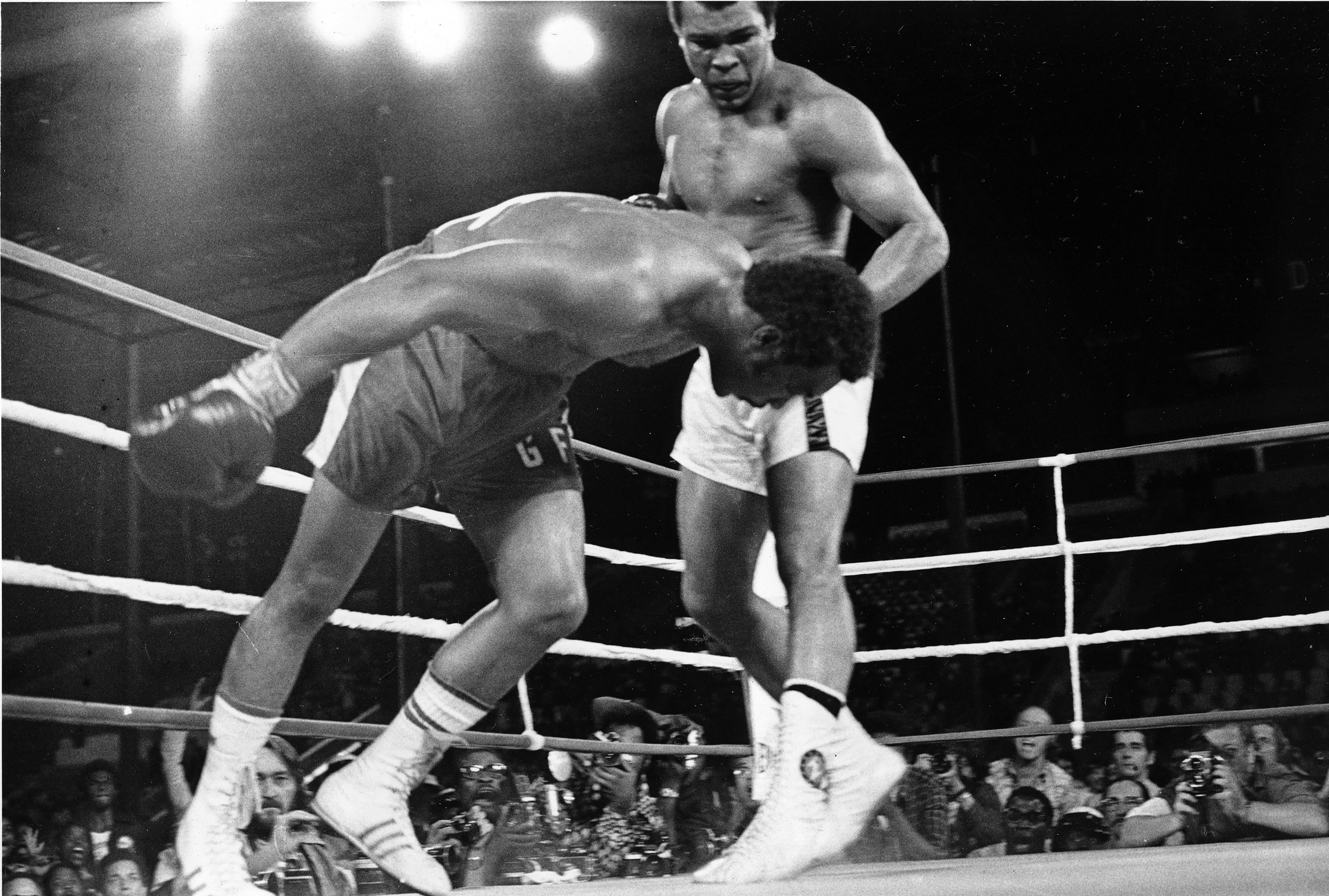 Challenger Muhammad Ali, right, watches as defending world champion George Foreman goes down to the canvas in the eighth round of their WBA/WBC championship match, on Oct. 30, 1974, in Kinshasa, Zaire.